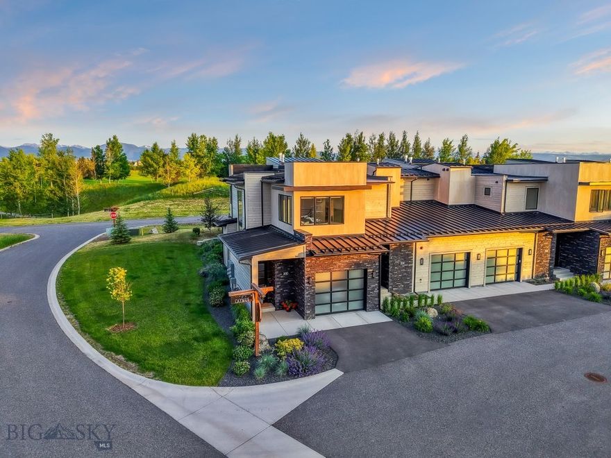 Welcome to 20 Caymus Lane Unit D — a luxury lock-and-leave villa in the coveted Black Bull Golf Community. Backing to open space with expansive views to the south and east, this end-unit residence offers a rare blend of tranquility, refined design, and resort-style living in Bozeman, Montana.

Enter through an oversized formal entry on the main level, where you'll find a heated 1-car garage with epoxy floors and generous storage. Upstairs, the heart of the home features a sunlit, open-concept layout with a gourmet kitchen outfitted with Thermador stainless steel appliances, a pantry, and a wet bar — ideal for entertaining. The primary living area flows into a cozy sitting room anchored by a sleek gas fireplace, leading out to a spacious back deck with natural gas hookup and panoramic open space views.

This 2,255 square foot villa offers two luxurious primary suites. The main suite boasts a floor-to-ceiling tiled walk-in shower and a custom closet system, while the secondary suite includes a soaking tub with tiled surround and another fully built-out closet. A half bath is conveniently located near the kitchen and living room. Additional features include a dedicated laundry area, central A/C, water softener, and window coverings throughout.

Black Bull HOA ($475/month) covers lawn care, snow removal, and exterior maintenance, plus access to world-class amenities including a private golf course (membership required), clubhouse, pool, fitness center, and miles of trails. With elevated finishes, unobstructed views, and low-maintenance living in Bozeman, this is your version of a permanent vacation — just minutes from Downtown Bozeman and the airport.