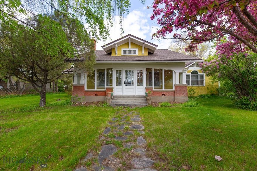 In the heart of Twin Bridges yet offering exceptional privacy, this 1915 Craftsman sits on 0.574 acres surrounded by mature landscaping, old growth trees, and fruit-bearing apple and pear trees. The 3,007± square foot, 4 bed, 3 bath primary home blends original details including hardwood floors, built-ins, and wood accents with spacious, flexible living. The glassed-in front porch offers a cozy space to enjoy the seasons year-round. The main level features a generous primary suite, additional bedroom, two full bathrooms, formal living and dining rooms, multiple sitting areas, a sunroom with radiant floor heat, and kitchen that retains its original charm alongside new appliances. Upstairs includes two large bedrooms and a full bathroom. The property includes a 650± square foot guest house with an attached 646± square foot two-car garage with added storage and work bench. The guest house features a new kitchen, new LVT flooring, a remodeled bathroom, a bedroom with walk-in closet, and flexible living space ideal for rental income, guests, extended family, or a home office. The private and inviting backyard is perfect for gatherings on the expansive 700± square foot back deck and includes a fire pit, fencing, and underground sprinklers. Situated near the Ruby, Beaverhead, Big Hole, and Jefferson Rivers, this is a rare chance to own a piece of history with modern comforts in a tranquil, in-town setting.