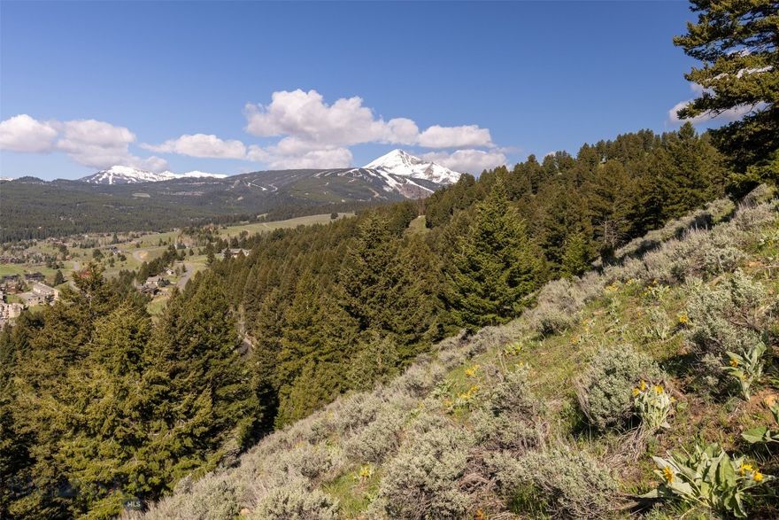 This 2.08 acre lot sits at the end of the Two Gun White Calf cul-de-sac, offering privacy and seclusion. The terrain is sloped and moderately treed, providing a natural and picturesque setting.

From this vantage point, the property boasts stunning south-facing views encompassing the entirety of Big Sky Meadow Village.

Convenience is key, with the golf course, post office, and Big Sky Town Center all just a five-minute drive away. For winter enthusiasts, skiing at Big Sky Resort is a mere 15-minute drive, making this location ideal for year-round enjoyment of all that Big Sky has to offer.