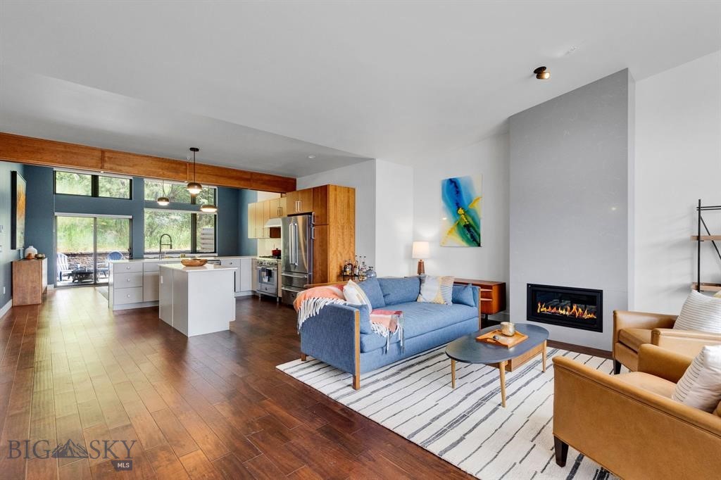 Contemporary design meets a coveted recreational setting in this turnkey Rattlesnake condo. Step out of your attached garage into the Rattlesnake National Wilderness, offering 61,000 acres to explore. After a day of adventure, unwind or entertain in the light-filled cook’s kitchen, which opens seamlessly to a private patio nestled against the pine-covered base of Mount Jumbo. The kitchen is both functional and stylish, featuring quartz countertops, a gas range, ample storage, and both an island and peninsula for extra seating. Inside, a subtle mid-century modern flair adds warmth and character. Three spacious en suite bedrooms, plus a half bath for guests, provide comfort and privacy. Two inviting living areas, a flexible bonus space, and thoughtful extras like two laundry areas and a Murphy bed enhance the home’s versatility. Cozy up to the gas fireplace in the winter or stay cool all summer with central air conditioning, this home is designed for comfort in every season.
