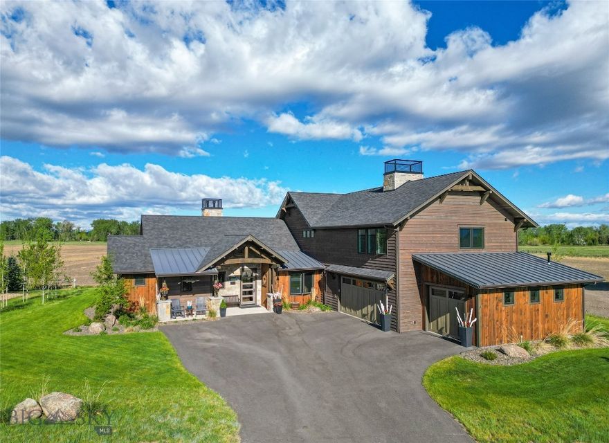 Experience privacy and some of the finest club amenities in the Black Bull Golf Club and Community in this luxury residence by ST Custom Homes. This 4-bedroom 3.5-bathroom home borders farmland offering unobstructed mountain views of the Gallatin Valley. The primary suite located on the main level has a spa inspired ensuite bathroom with heated floors, a deep soaking tub and massive shower with multiple heads. Enjoy direct access to your back patio and gas fireplace via large sliding doors. Soaring ceilings accented with reclaimed barnwood and a floor-to-ceiling tiled gas fireplace anchor the open-concept living space. The chef’s kitchen features a premium Thermador suite of appliances, modern integrated cabinetry, and sleek quartz surfaces, complemented by a dedicated wet bar and wine cooler for effortless entertaining. The two additional bedrooms connected by a Jack-and-Jill bath, a private home office, and a functional mudroom/laundry hub complete the main level. Upper Level offers a versatile bonus wing featuring a fitness space, a large media area, and a private guest suite with a full bath. The heated 3 car garage demands attention with 1,100 square feet, perfect for all your Montana toys. Attached to the garage is an exterior dog run with a dog door installed. As a resident of Black Bull, you’ll have access to a world-class Tom Weiskopf-designed golf course, a private clubhouse, a fitness center, and a pool, all just minutes from the heart of Bozeman.