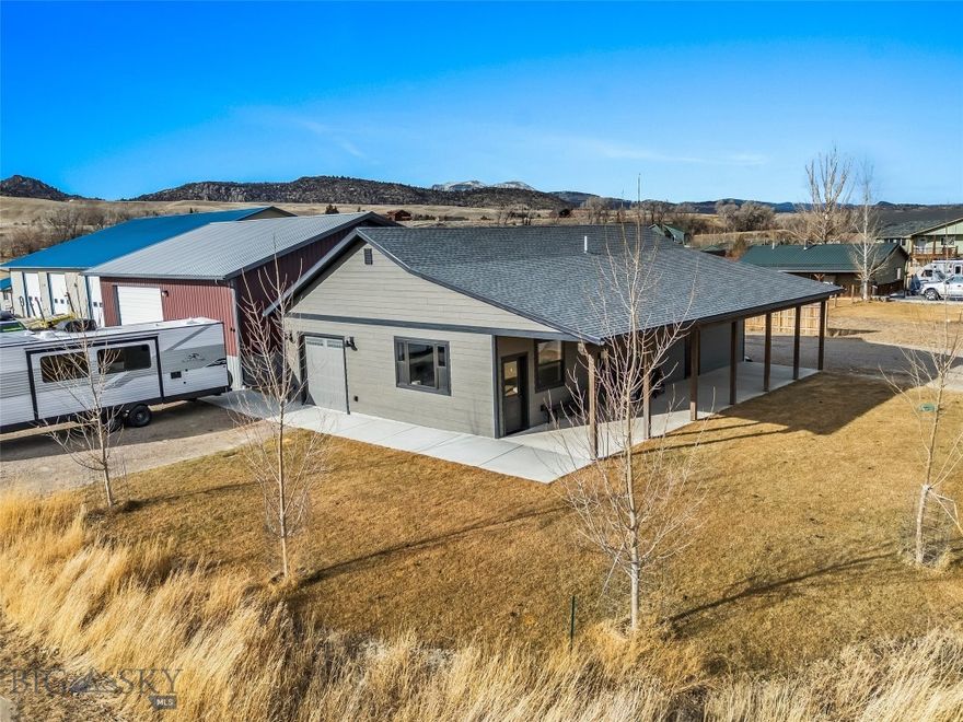 One-of-a-Kind Live/Work Property in Ennis, Montana. Opportunities like this rarely come along in Ennis. This exceptional commercial/residential property offers the ultimate live-work setup, investment potential, or business headquarters with no other property currently on the market quite like it. The 40’ x 40’ fully insulated metal shop features 14’ walls, a 12’ x 16’ overhead door, and is built to perform. The shop includes a 16’ x 18’ office with electric baseboard heat, a kitchenette, and a ½ bath. It is plumbed and prepped for radiant floor heat (boiler needed) and currently heated with a wood stove. Construction highlights include spray-foam insulated walls, blown-in ceiling insulation, a full metal exterior and roof, plus a storage mezzanine for added functionality.
Outside, you’ll find 30 & 50 amp RV hookups with dump, along with ample extra parking ideal for equipment, trailers, work vehicles, or recreational toys. Next to the shop sits a beautifully built 2023 home offering 1,224 sq ft, 3 bedrooms, and 2 bathrooms. The home features granite countertops, alder cabinetry in the kitchen and baths, and tasteful modern finishes throughout. The primary bedroom is generously sized with an ensuite bath showcasing a custom tile shower. Additional features include an on-demand water heater, forced-air propane heat, central air conditioning, and a landscaped yard with underground sprinklers. This versatile property opens the door to endless possibilities like a live/work operation, contractor or trades headquarters, automotive, fabrication, or equipment shop, storage and rental income, short or long-term residential rental, business with on-site owner housing, recreational basecamp for RVs, boats, and gear. Located in the heart of Ennis, you’re minutes from world-class fly fishing on the Madison River, with easy access to hunting, hiking, horseback riding, snowmobiling, and public lands in every direction. Ennis offers a vibrant small-town atmosphere with stunning mountain views and endless outdoor recreation. Unique, flexible, and impossible to replicate, this is a rare Ennis offering you don’t want to miss.
