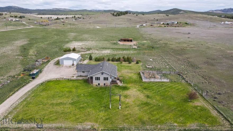 Discover the perfect blend of country living, equestrian functionality, and modern comfort on this exceptional horse property with no covenants and endless opportunities to enjoy the Montana lifestyle. This spacious 2,656 sq ft home features a desirable layout with a main-level primary suite and two additional guest bedrooms on the main floor. The open kitchen flows into a spacious living room where oversized windows showcase breathtaking views and flood the home with natural light. Home has central A/C throughout for year-round comfort. The fully finished basement offers an expansive family room, along with two bonus rooms and a bathroom that provides flexible space for an office, gym, hobby room, or additional sleeping areas. Outdoor living is equally impressive with covered front and back porches designed to take in the incredible scenery and peaceful surroundings. The large fenced yard includes automatic underground sprinklers and raised garden beds and the mature landscaping creates a beautiful and functional outdoor space. Horse enthusiasts will appreciate the well-equipped setup featuring covered corrals with 3 stalls, a dry lot, automatic waterer, grazing pastures, and a 75x150 outdoor riding arena. Ride directly from your property or down the road and enjoy nearby BLM access for endless horseback riding opportunities. A heated 30x48 shop provides ample space for equipment, toys, projects, or storage, while the chicken coop with both heat and A/C adds even more versatility to this thoughtfully designed property. Located just 10 minutes from Hauser Lake, this property offers the ideal combination of privacy, recreation, and convenience, with room to truly enjoy the outdoors, entertain guests, and embrace the rural lifestyle. Make your showing appointment today before it's sold!