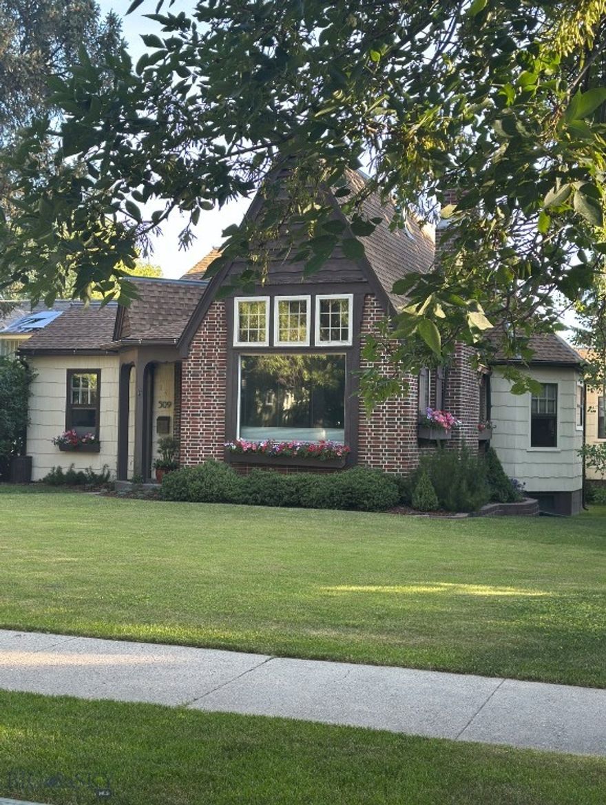 This wonderful south Bozeman home is like no other. Known as "The Gingerbread House" on Cleveland Street, this delightful home has the charm you desire and the versatility you need, all in one of Bozeman's most desirable neighborhoods.  This Fred Wilson designed home was built in 1938 and features 5 bedrooms with 3.5 baths. There are 3 bedrooms on the main level. 1 bedroom is off the front entry, the other 2 are the master and the quest, both are ensuites. The stunning master bath remodel was completed this summer. There is also an oversized bedroom downstairs that has a 3/4 bath and oversized closet and a storage closet. (No Egress Window). The large bedroom upstairs has new carpet, a walk-in closet and 1/2 bath, ready for your master closet, den, studio or bedroom! This large lot (.234 acres) is beautifully landscaped with shrubs and perennials and the BBQ pad, the firepit and "Treehouse" out back create your magical outdoor dining and entertainment experiences. The living room features 13 ft cathedral ceilings with gorgeous woodwork, built in shelves, gas fireplace and a massive picture window facing south. The formal dining room with 2 corner-built ins creates a classic look and allows extra storage, not that you will need the storage, this home features storage galore! Through the back door mudroom, you enter the functional kitchen with good flow, stainless steel appliances and informal dining. The basement is unfinished except for the bedroom; there are all kind of possibilities for this space and the storage room next to it. With 3150 sq ft on 3 levels this home lives large, an addition of an ADU would only add to that. 2 car detached garage with shared drive. New water heater installed October '25.