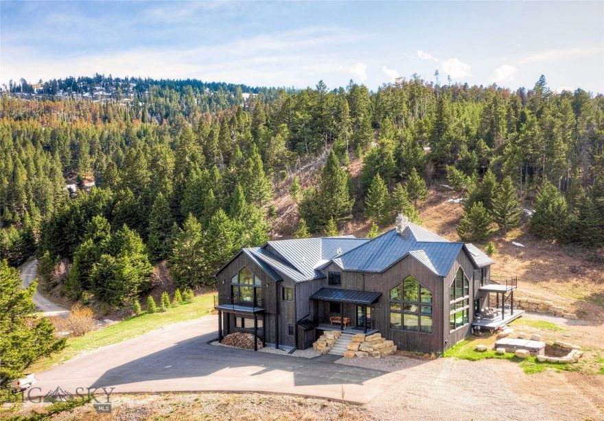 Experience Montana Mountain Luxury At 280 High Ridge Road!
Discover Your Private Sanctuary in This Spectacular 5900+/- Sq Ft Custom Home, Meticulously Reimagined In 2023. Wake Up to Breathtaking Mountain Vistas and the Tranquility of Nature While Enjoying Every Modern Luxury at Your Fingertips.  Rustic Charm Meets Contemporary Elegance in This Four-Bedroom, Four-Bath Retreat, Taken Down to the Studs and Expanded to Perfection. The Chef’s Kitchen Shines with Custom Cabinetry, Top-Tier Appliances and an Effortless Flow For Entertaining, Complemented By Surround Sound Speakers Inside and Out For The Perfect Ambiance.
Designed For Work, Relaxation and Gatherings, This Home Features Two Private Bedroom Suites, Dual Offices for Ultimate Productivity and a Grand Great Room with Vaulted Ceilings, Floor-To-Ceiling Windows and a Commanding Stone Fireplace that Creates a Warm, Inviting Atmosphere.
Step Outside to Your Year-Round Bullfrog Swim Series Swim Spa and Soak in Panoramic Views in All Seasons. For Those Who Value Independence, This Home is Equipped with Off-Grid Capabilities, Including A Solar Power/Battery Backup System and a Generac Generator for Added Peace of Mind.
The Expansive Five-Car Garage Offers Ample Space for Vehicles, Recreation Gear and All Your Montana Toys. Every Inch of This Home Reflects Superior Craftsmanship, Seamlessly Blending Modern Convenience with Serene Mountain Living.
280 High Ridge Road Isn’t Just a Home—It’s a Lifestyle, Where Peaceful, Quiet Living and Convenience Coexist in Perfect Harmony.