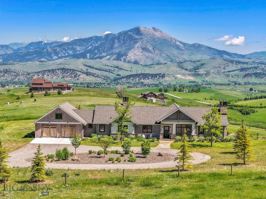 Welcome to 168 Hawthorn Lane, a rare offering that combines modern elegance, luxurious finishes, and the serenity of Montana living on 10 pristine acres. This location is prime, as the property is only a short 10-minute drive to bustling downtown Bozeman! Perfectly positioned to capture sweeping Bridger Mountain views, this stunning home offers effortless, single-level living designed for comfort, style, and connection to Bozeman's natural beauty. Built in 2020 with an emphasis on sustainability, the home features a 15kW solar array, a Lunos air exchange system, and low-VOC materials throughout—making it as environmentally conscious as it is beautiful. The entire home, including the garage, is equipped with radiant floor heat, ensuring cozy comfort in every season. The thoughtfully designed floorplan offers light-filled living spaces with an easy, elegant flow. At its heart is a chef’s kitchen with beautiful marble countertops, a stainless steel prep island with seating for guests to gather, high-end appliances, and a pantry for all your culinary needs. The thoughtfully placed kitchen window offers mesmerizing views of the Bridger Mountains, making time spent in the kitchen feel inspired. The inviting dining room is perfectly sized for large family gatherings, while the open living area, anchored by an attractive rock gas fireplace, provides a warm and comfortable space to gather with friends and loved ones on chilly Montana evenings. Glass doors open to the covered patio and perfectly sized backyard, complete with a sitting area and firepit—an ideal place to unwind and take in the stunning views. The sizable primary suite is a true sanctuary, featuring its own rock gas fireplace and a cozy office nook for quiet reflection or productivity. The adjoining bathroom features a soaking tub thoughtfully placed within the spacious walk-in shower and dual vanities. Two additional well-appointed bedrooms and a large full bathroom offer plenty of space for family and guests, completing the home’s thoughtful layout. And for music lovers, the home is equipped with a Sonos surround sound system, creating an immersive audio experience indoors and out. With 10 acres of room to roam, this property also allows for horses, and space to add a barn, shop, or ADU. All of this in Bozeman’s highly sought-after southeast side—close to downtown yet surrounded by natural beauty. This is more than a home, it's a lifestyle—refined, relaxed, and uniquely yours.