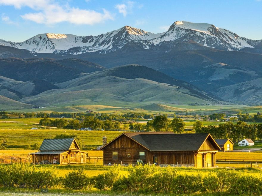 Experience the essence of Montana living in this custom-built, country-contemporary 4-bedroom, 2-bathroom home, set on over 1.5 acres along the scenic hillside of Harrison—one of the state’s most picturesque small towns. Surrounded by sweeping 360-degree mountain views and just 4 miles from Harrison Lake, this property offers the perfect balance of seclusion and convenience. Enjoy nearby access to public lands, the iconic Pony Bar, and endless outdoor recreation, including hiking, fishing, and hunting. Centrally located, it's just 20 minutes to Three Forks, 30 minutes to Ennis, and under an hour to Bozeman via I-90.

Thoughtfully crafted with attention to detail, the home features fir flooring, wood beam accents, stainless steel appliances, custom tile backsplashes, and a warm brick accent wall in the basement. A bungalow-style covered wraparound porch with hemlock and bead-board finishes, along with stone pillars and exterior accents, lends the home timeless Montana character.

A spacious attached 2-car garage and a detached three-stall shed provide ample room for vehicles, storage, and gear. With panoramic views of the Tobacco Root Mountains from nearly every angle, this home offers a peaceful, private setting—and a rare opportunity to enjoy the Montana lifestyle where space, scenery, and craftsmanship meet in one truly special place.