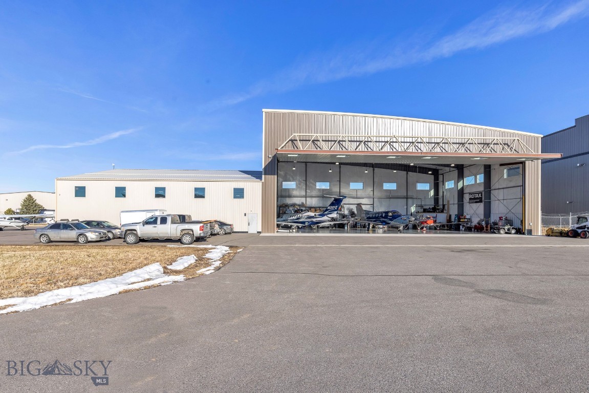Situated at the heart of Montana's most dynamic airport, this stunning 14,000 SQFT commercial hangar at Bozeman Yellowstone International Airport is a rare gem. Offering an expansive 11,900 SQFT of hangar space complemented by 2,100 SQFT of premium office accommodations.
The hangar features two impressive doors—90' x 28' and 66' x 16' 6”—with an open, internally connected layout, ideal for a variety of aviation uses and 3 phase power carts. The office space includes a welcoming reception area, two well-appointed bathrooms, and four executive offices with expansive windows, plus two additional offices without windows. The versatile open space can easily accommodate more workstations, cubicles, or even a classroom setup, providing the flexibility to meet the unique needs of your business.
Currently operated as a flight school, charter service, and aircraft maintenance/management facility, this is the only hangar for sale in Bozeman that meets commercial standards, including public access to the front entrance. Situated on leased land, the buyer will assume the terms of the existing lease or negotiate a long-term, 20-year lease directly with the Bozeman Airport Authority, to be executed at closing.
This exceptional property represents a rare opportunity to own a state-of-the-art aviation facility in one of the most sought-after regions in Montana.
