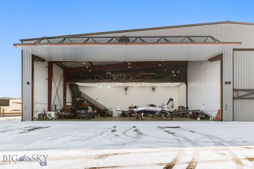 Rare find at BZN!!! 80x74 Box Hangar with a 74x29 Hangar door. Mezzanine pilots lounge with theatre, bathroom with shower and pool table area so you can relax before takeoff. Hangars with doors this large are extremely hard to find. +/- 5920 sq/ft main level and +/- 1920 sq/ft Mezzanine.  Buyer to verify measurements.