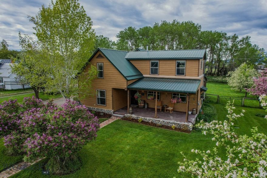 Just a short distance from Main Street in Sheridan, this beautifully updated 4-bedroom, 3-bathroom home offers 2,295± square feet of living space on a 0.459± acre lot. Fully remodeled in 2014, the home blends modern convenience with small-town charm. Step onto the welcoming covered front porch or relax on the spacious covered back patio overlooking a large, manicured lawn. The fenced backyard is ideal for outdoor living, complete with underground sprinklers, mature plum and crab apple trees, lilacs, garden areas, and a chicken coop. Inside, the thoughtfully designed floor plan features a kitchen with adjoining dining area, abundant storage, and comfortable living spaces to suit a variety of needs. The remodel brought updates throughout, providing refreshed finishes and a functional flow. A durable metal roof, ample storage options, and inviting outdoor spaces add to the property’s appeal. With its prime location close to town amenities and a setting that offers both charm and practicality, this Sheridan home is move-in ready and designed for everyday enjoyment.