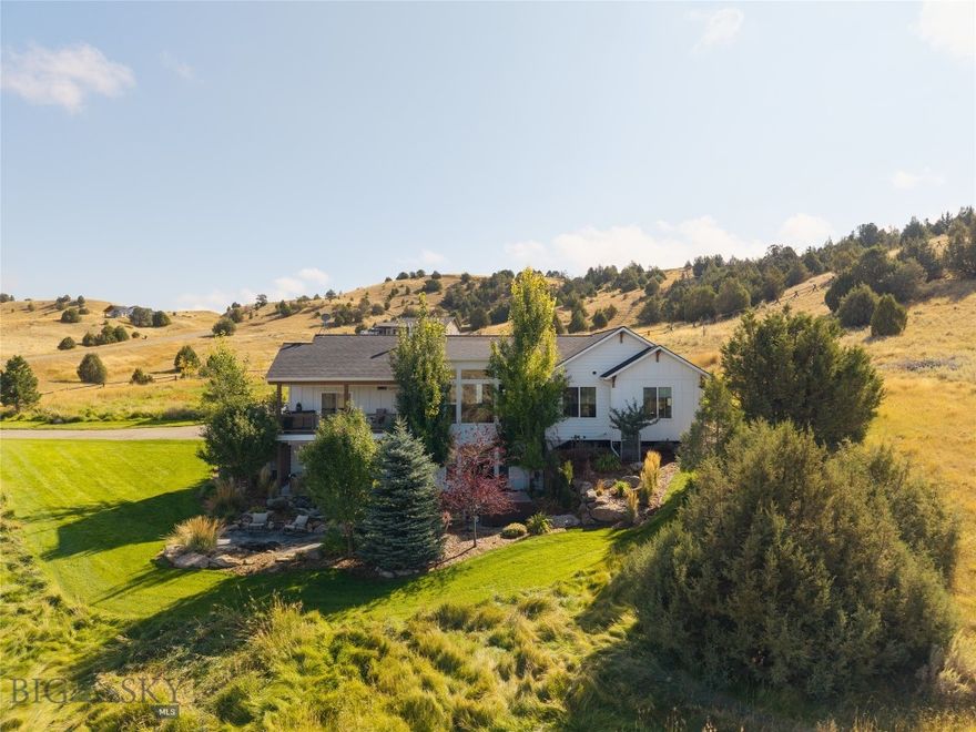 Breathtaking Views, Elevated Comfort, and True Montana Living - Just 15 Minutes from Bozeman

Welcome to 388 Pacer Landing - where country tranquility meets upscale comfort on nearly 9 acres of hillside paradise just off Norris Road. Nestled in the scenic Manhattan countryside, this stunning 5-bedroom, 2.75-bath custom home offers sweeping Tobacco Root Mountain views, vibrant outdoor living spaces, and the kind of thoughtful design that makes everyday life feel like a retreat.

Inside, the home stuns with vaulted ceilings, oversized windows, and an open-concept main floor that brings light, space, and views into every room. Entertain effortlessly from the kitchen to the inviting living and dining areas - all flowing seamlessly together for gatherings large or small. The primary suite features a private ensuite bath and walk-in closet, while two additional bedrooms and a full bath offer more main-level dwelling.

The walkout daylight basement expands your options with a large second living area/movie room, two more bedrooms (one converted into a home gym), a third bathroom, and generous storage space.

Head outside to three covered outdoor living areas including a covered front porch, upper-level deck, and lower patio, all surrounded by mature trees and curated landscaping for privacy and comfort. A firepit patio faces west toward sunset views, while a landscaped creek and pond create a peaceful focal point for outdoor relaxation. The yard is supported by a full irrigation system with sprinklers and drip lines, multiple boulder retaining walls, and colorful landscape beds.  Juniper trees and wandering wildlife bring the land to life, creating a peaceful connection to nature.

Additional features include: Hot tub with views, insulated 30x40 shop with wood stove and 12' ceilings, laundry/mudroom off the 2-car garage, room for animals, gardening, or expansion, and peaceful country roads ideal for walking and connecting with neighbors.

Whether you're looking to raise a few animals, host unforgettable gatherings, or simply live immersed in Montana beauty while staying close to Bozeman, 388 Pacer Landing offers it all.