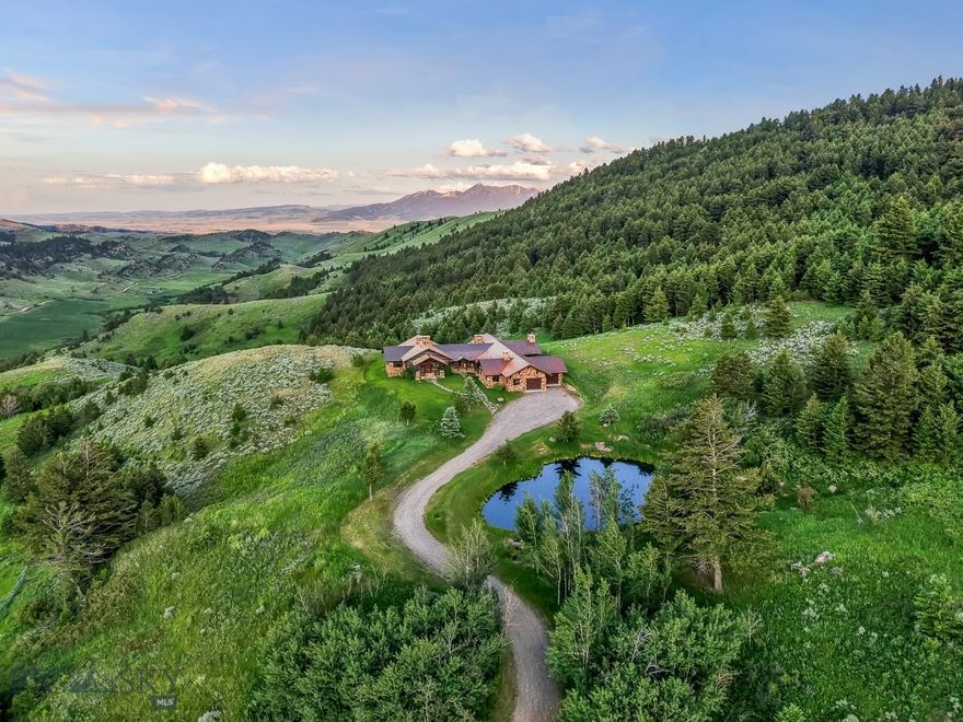 Sky Band Ranch, at the southern base of the Bangtail Mountains captures the magic of Southwestern Montana. Its location between the treasured towns of Bozeman and Livingston makes it even more desirable. The ranch spans +/- 262 serene acres offering the freedom to mountain bike, hike, horseback ride, hunt, snowshoe or cross-country ski right out the back door. It supports horses or other livestock. Area Creek (also known as O’Rea Creek) runs on the ranch for approximately 1/3 mile. The gorgeous western-style residence and pond are tucked upon a hilltop bordered by timbered hillsides, lush meadows and creek bottom providing refuge to elk, deer, moose, bear, grouse, Hungarian partridge, and other impressive wildlife. The residence built in 2008 exemplifies exceptional craftsmanship and meticulous attention to detail, effortlessly combining rustic style with attractive finishes perfectly integrated into the striking Montana landscape. Massive amounts of stone were brought in for the outdoor patio area, some interior and exterior walls, and five substantial fireplaces. Hewn Douglas fir was used for the interior and exterior walls. Custom made cabinetry, solid wood doors, trim and gorgeous wide plank fir flooring which has been recently refinished to perfection are found throughout the main floor. Pella windows and French doors frame the beautiful landscape of mostly ranch land with the Absaroka Mountains as its backdrop. Massive wood beams/trusses and impressive two-sided stone fireplace anchor the sun filled open floor plan of the living/kitchen/dining area creating a wonderful lodge atmosphere for gatherings or hunkering down with an enjoyable book. Additionally, there is a dedicated office/library, a spacious laundry room, and an oversized attached two-car garage. Downstairs is a 4,758 sf partially finished walk out basement offering endless possibilities. Excellent candidate for a conservation easement. Sky Band Ranch offers an extraordinary Montana lifestyle for outdoor enthusiasts seeking stunning views, open space and nature near world-class amenities.