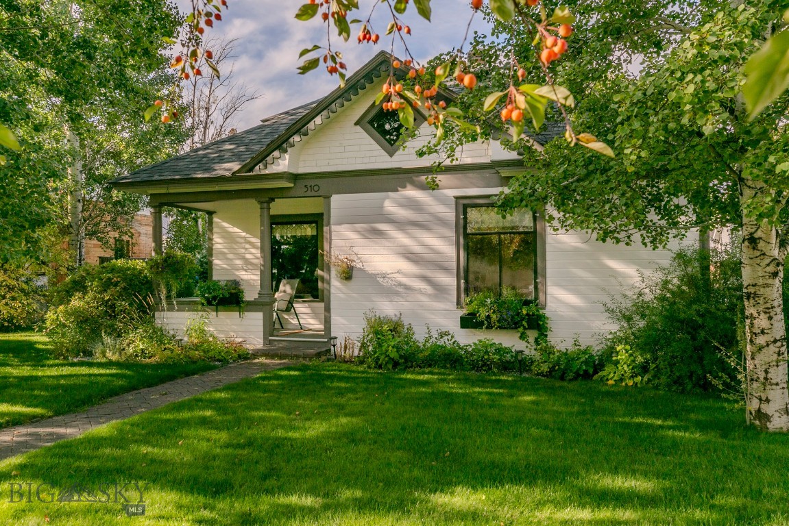 Timeless charm in the heart of Big Timber! You’ll appreciate the vintage character and modern comfort the moment you step inside this beautifully cared-for 1904 home. Original oak floors, pocket doors, and bright, welcoming rooms blend seamlessly with thoughtful updates throughout. The yard is beautifully landscaped with mature quaking aspens, colorful flower beds, and a classic white picket fence—enhanced by a seasonal shared well for convenient irrigation. A detached garage with workshop and alley access complete this picture-perfect home.