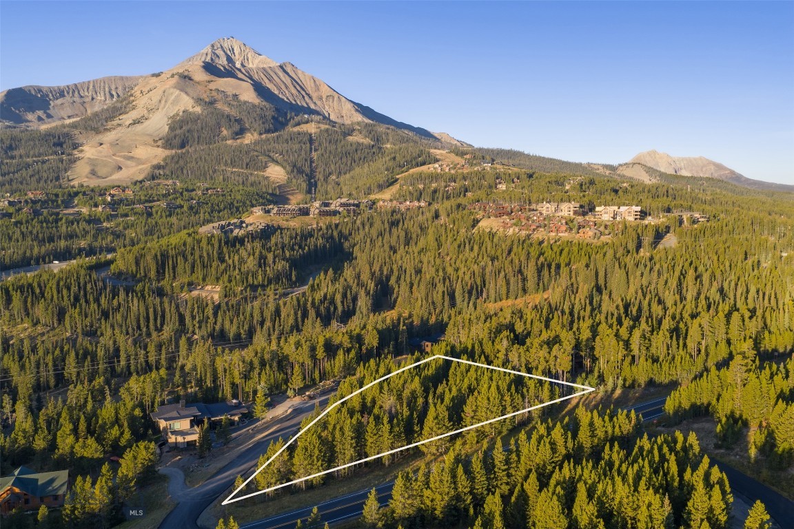 TBD Little Wolf (Lot 263) is a 1.055-acre homesite in Big Sky’s Cascade Subdivision where the views truly steal the show. Lone Peak rises up so close it feels like you could reach out and touch it, while Andesite Mountain and the surrounding forests create an unforgettable backdrop for your future mountain retreat. The lot features gently sloping topography with mature trees, offering both buildability and a natural sense of privacy. Nestled within an established neighborhood, it combines community with the feeling of being tucked away in the mountains.
Ski access is possible with a few road crossings, giving you the option to click in nearby, but the real appeal here is year-round. Whether it’s powder days, summer hikes, mountain bike rides, or evenings on the deck watching alpenglow settle on Lone Peak, this location makes it easy to live the Big Sky lifestyle. With its dramatic views, four-season recreation, and prime mountain setting, TBD Little Wolf is an exceptional opportunity to create your own basecamp in Big Sky. Don’t miss your chance to secure one of Cascade’s most captivating lots—reach out to your favorite Big Sky real estate professional to learn more.