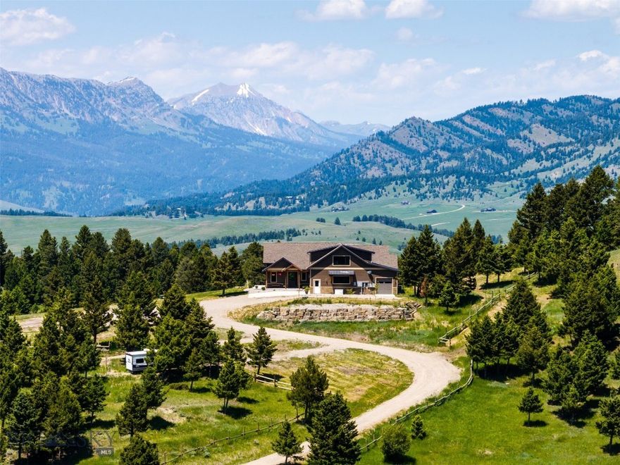 Perched on a tranquil 10-acre parcel on a ridge atop Bozeman Pass, this stunning residence embodies the Montana lifestyle. Built in 2020, this 5900+ sq ft home is situated in a gated neighborhood with conservation land adjacent, capturing mountain vistas from every window. Located only 20 mins from Bozeman’s historic Main Street, this exceptional property feels a world away and has NO freeway noise. Enjoy stargazing and watching Montana skies while enjoying the abundant wildlife that frequents the property, including elk, moose, deer, bear and more. Light CCRs - no county zoning - buyer to verify. This home was designed to maximize comfort while still enjoying the mountain lifestyle. Huge upgrades - separate list available - Radiant heating and multiple mini split A/Cs for cooling, 9’ ceilings. Vaulted living room features huge views, a striking floor-to-ceiling stone gas fireplace, and hardwood. Corner office. Chef’s gourmet kitchen with custom cabinetry, GE Café appliances, granite and plentiful prep space. Dining area with access to the covered patio with in-floor radiant heat, perfect for entertaining. Mudroom/laundry area offers storage, an extra-large pantry, a built-in pet wash, washer/dryer. Main-level primary suite with deck access - spa-like primary bath with heated floors, double vanity, heated towel bar, soaking tub and tile shower. 2nd bedroom with ¾ bath and a powder room on main. Extra wide stairs lead up and down. Bonus room on 2nd with full bath access - great for additional guest quarters. Daylight lower level/walk-out, 2nd concrete patio with radiant heat. Expansive game room, a guest bedroom with patio access, a gym and a ¾ bath on lower level. 1,818-square-foot, 4 bay/5-car attached garage with radiant floor, HRV system. Vault door lock-off safe room with storage. Adventures await – a two-stall Monitor horse barn will delight equestrians and a 2 bay 760+ sq ft toy storage shop with carport is perfect equipment storage. Two 1,000-gallon propane tanks, a 20 gal/min well, GENERAC emergency backup power system, a hot water recirculation pump and Starlink internet. Marvin Ultimate windows + custom treatments, Sonos. Mitigation of vegetation and irrigated grounds around the structures. RV and equipment parking. Additional equipment incl. skid steer and plow truck available for separate purchase. 28 mins to MSU, 22 mins to hospital, 35 mins to Bridger Bowl, 23 mins to Livingston and blue ribbon fishing. Don’t miss the VR Matterport 360 tour!