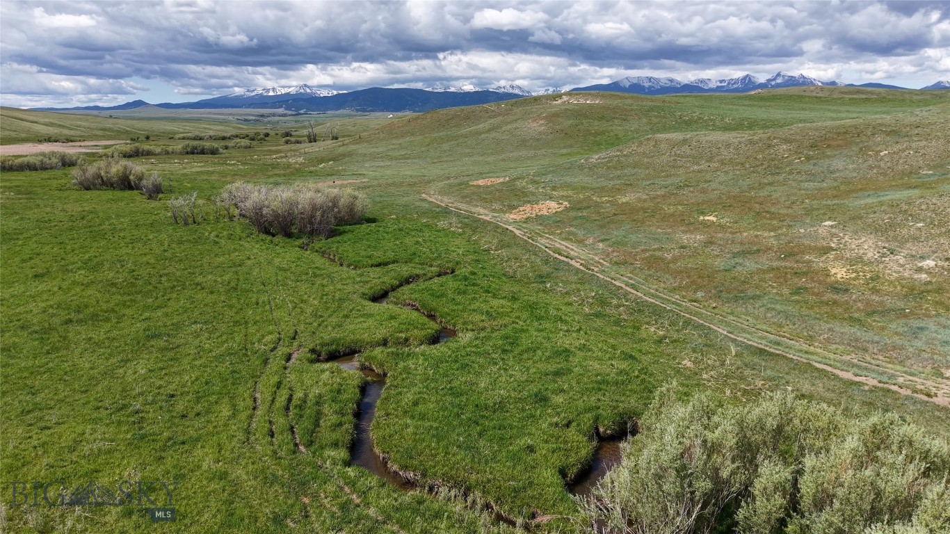 Norwegian Creek 480 is part of the historic 126+ year-old Maichel Ranch, located just outside of Harrison, Montana. Set beneath the Tobacco Root Mountains and just upstream from Harrison Lake, this 480-acre property offers 1/2 mile of creek bottom privacy, open space with huge views, and strong potential for an equestrian estate, small ranch, or private retreat.
The land consists of three 160-acre legal parcels with multiple building sites ranging from private, wooded creek areas to open hilltops—all offering sweeping 360-degree views. The property borders a 640-acre section of State land with another mile-plus of Norwegian Creek frontage, further expanding recreational access and ensuring an extremely private setting with no other homes in view.
Over 200 acres of the property can be farmed or cropped separately for food plots, grain production, or other agricultural uses. Elk, deer, upland birds, and other wildlife are frequently seen on the land, enhancing its appeal for hunting and outdoor enjoyment.
Located at the end of the road on the historic Maichel Ranch, the property provides excellent privacy with convenient access—just 45 minutes to Bozeman and 20 minutes to Ennis. Nearby power and road improvement materials can be made available by the seller with an acceptable contract, offering additional development flexibility. Seller offers to lease property for grazing purposes to create cash flow for new owner.
Generations of careful stewardship are reflected in Norwegian Creek 480’s productive capacity and natural beauty, making it a rare opportunity in southwest Montana.