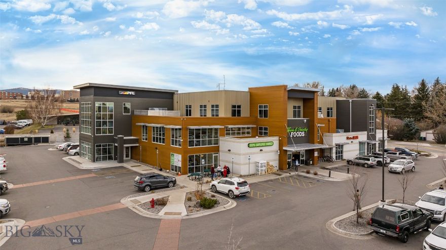 Position your business (or investment portfolio) in one of Bozeman’s most recognizable and convenient corridors—the East Main Street gateway, at the high-visibility corner of E Main St & Highland Blvd, in a 2019-built modern mixed-use building directly connected to daily amenities, including Town & Country Foods onsite. Suite 202 offers approximately 2,024 SF of flexible commercial condo space with a clean, professional feel and the kind of bright, window-lined environment today’s tenants and owner-users actively seek. The building is served by an elevator, making it easy for clients, staff, and deliveries. Also included is a common conference room, large restrooms with lockers and showers and shared kitchenette space. From this address you’re set up for business across the Gallatin Valley—quick access to Downtown Bozeman, the East Main commercial corridor, and straightforward routes toward Belgrade and I-90. For out-of-town clients and Montana lifestyle draw, Bozeman places you within striking distance of Big Sky, Bridger Bowl, Hyalite Canyon, and day trips toward Yellowstone National Park—a huge plus for businesses that attract visitors, second-home owners, and regional clientele. Ideal for: professional office, medical/therapy/wellness, creative studio, boutique service business, or a long-term hold in a supply-constrained market.