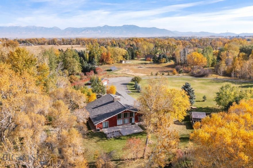 Discover a rare opportunity to own a truly unique property in Bozeman, Montana, offering space, privacy, and versatility on nearly 3 acres. This expansive 5,395± SQFT residence combines comfortable living with exceptional functionality.
The main home features 3 bedrooms and 3.5 baths, thoughtfully designed to maximize space and natural light. Originally built in the late 1970s, the home showcases a distinctive retro character that has been thoughtfully preserved and enhanced, offering a one-of-a-kind aesthetic you won’t find in newer construction. Warm, inviting living spaces are anchored by a beautiful fireplace, while refurbished hardwood floors add timeless appeal and quality craftsmanship throughout. The bathrooms have been tastefully updated with tile flooring and new fixtures, blending modern convenience with the home’s original charm.
The fully redone basement adds incredible versatility, offering endless possibilities—whether you envision a home theater, wine cellar, den, gym, or additional entertainment space.
Outdoor enthusiasts and hobbyists will appreciate the incredible amenities, including ample garage space of over 1400± SQFT in two separate detached structures. Providing plenty of room for vehicles, equipment, and recreational toys. The property also includes a 50 amp RV hookup, making it ideal for travel-ready lifestyles.
Enjoy the peaceful Montana setting with approximately 645± feet of Dry Creek running along the property, creating a serene, natural backdrop and a rare opportunity to own a substantial stretch of creek frontage. Whether you’re relaxing outdoors or simply taking in the views, the setting offers a true connection to nature.
Situated on 2.96± acres, this property provides privacy while still being conveniently located within the highly regarded Monfortan School District. A private septic system, private well and water rights for lawn irrigation add to the property’s independence and functionality. This is truly a must-see property.