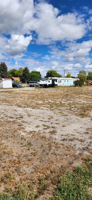 12 hard to find lots in Dillon MT consisting of 1.71 acres near Safeway and schools. Quiet neighborhood with city water and sewer to the lots. These are the most favorably priced lots in Dillon at under $52,000 per lot. Zoning allows single family, multi-family, cottage business, mobile spaces or mix it up and do it all. If you are looking for less or just one large home site, make an offer on 4, 6 or 12 lots. Dillon always need quality, single level Senior living. Lots are 183' deep and can be access from Barnett or Vine Streets or the alley. Eight mobile homes currently rent space and all are on a 30 day rental period so they can be moved or rents increased to market rate. Many options.