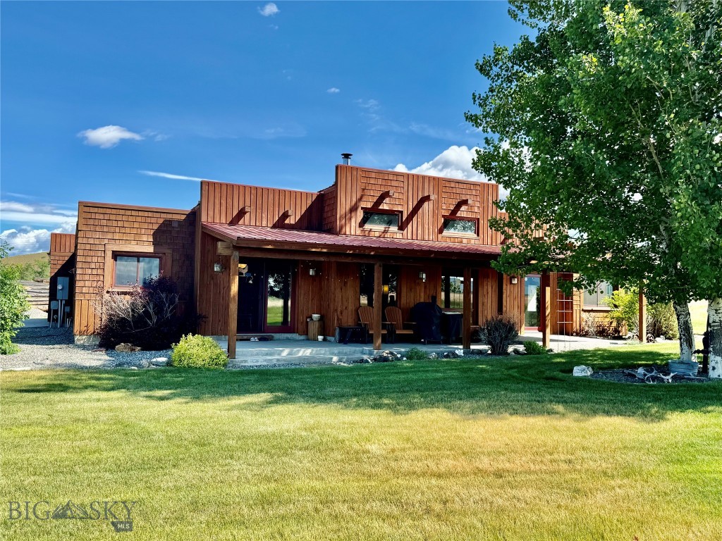 Welcome to this one of a kind custom built Southwestern-style home, perfectly situated on 4 acres with no HOA or covenants. Built in 2002 this thoughtfully designed open-concept, one level home features 3 bedrooms, 2 full bathrooms, a separate office, and a well-appointed kitchen with coffee bar area. The primary suite includes a walk-in closet, large en suite bathroom with jetted tub and separate tile shower. The two additional bedrooms share a full bathroom. The living room has a rustic charm provided by the accent wood beams in the ceiling, large windows and a wood burning stove for warmth, creating the perfect setting for relaxing evenings. The spacious layout flows effortlessly, offering room to gather or unwind in your own quiet corner. There is a oversized one car attached garage that offers plenty of room for your vehicle, storage and toys but for hobbyists, professionals, or anyone in need of extra space, the 40x40 detached shop is a true standout. Perfect for a workshop, studio, RV storage, or home business, this versatile space is fully insulated and powered and ready to meet your needs. A large, fenced garden area invites you to grow your own vegetables, produce, or flowers. There is also an insulated and powered storage shed beside the garden to store your tools and equipment. You can truly make this property your own—whether you're dreaming of homesteading, adding animals, or simply enjoying wide-open space and privacy. Enjoy the sweeping views, mature landscaping with underground sprinklers and the wide-open feel. Whether you're relaxing under the covered patio or exploring the surrounding grounds, you'll love the peace and privacy of this beautiful property. Call for a showing today!