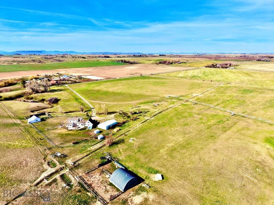 The ground is currently leased for cattle, demonstrating its proven capacity to support livestock while offering immediate income potential for a new owner.
Supporting the operation is an impressive lineup of outbuildings and ranch infrastructure. A 40’ x 40’ Quonset, 36’ x 50’ shop, horse barn, chicken coop, greenhouse, fuel stands with tanks, and multiple storage buildings provide ample space for equipment, livestock care, feed, and projects of every scale. Whether your vision includes expanding a cattle operation, establishing a hobby farm, or simply enjoying the freedom of rural living, these improvements add tangible, hard-to-replace value.
At the center of the property sits a home that has been completely reimagined inside, offering modern systems, elevated finishes, and timeless character. The kitchen stands as a true focal point—designed for both functionality and gathering—featuring a six-burner propane Viking range, built-in microwave, and a double-drawer Café dishwasher, paired with butcher block countertops, sleek cabinetry, and high-end appliances throughout. It’s a space built for those who value both serious cooking and everyday comfort. Beyond the kitchen, a long list of upgrades includes a new reverse osmosis water system, new furnace and air conditioning, on-demand hot water heater, new flooring throughout, and a new well pump and controls. Original details add warmth and character, including a refinished wood staircase, wood and pellet stoves, and a whitewashed brick fireplace.
Beyond the property lines, the Vaughn area offers exceptional outdoor recreation and lifestyle appeal. The nearby Sun River and Missouri River provide outstanding fishing and floating opportunities, while wildlife areas, open landscapes, and Montana’s renowned hunting districts surround the region. Just minutes away, Great Falls offers healthcare, shopping, dining, cultural attractions, and a commercial airport with direct flights to major hubs—making this location as convenient as it is peaceful.
This property is a place where the land works, the home comforts, and the lifestyle delivers exactly what so many are searching for.
