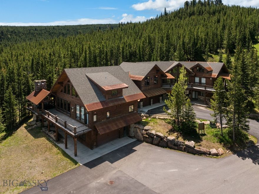 Welcome to 396 Lower Promontory, a true Big Sky retreat where privacy, recreation, and timeless mountain design converge. Nestled on over 19 acres with sweeping views of the Spanish Peaks and Gallatin Range, this property combines serenity and convenience—just 25 minutes from world-class skiing at Big Sky Resort, a short drive to the Gallatin River, and direct neighborhood access to snowmobiling, ATV, hiking, and biking trails.
Spanning nearly 7,500 square feet, this thoughtfully designed estate features five bedrooms, a custom sleeping nook, seven full bathrooms, three living areas, and a spacious game room, providing ample space for family and guests. Two fully equipped kitchens make entertaining effortless—perfect for hosting holidays or gatherings when everyone wants to experience life in Big Sky.
Enjoy over 2,000 square feet of decks and porches, including an outdoor dining area beside a massive stone wood-burning fireplace—the perfect setting for summer dinners, stargazing, or making s’mores under Montana’s vast night sky. A spring-fed pond with a custom rock waterfall adds a tranquil touch to the property, creating your own private mountain sanctuary.
Built in 2014 with a substantial addition completed in 2019, the home blends modern finishes with enduring mountain architecture. A pristine asphalt driveway leads to two garages, providing abundant space for vehicles, outdoor toys, and recreational gear.
Located within Buck Ridge Ranch, the only neighborhood in Big Sky with direct trail access to thousands of acres of U.S. Forest Service land, residents enjoy a truly unique privilege—unparalleled adventure right from the doorstep.
396 Lower Promontory is more than a home; it’s an invitation to live the Big Sky lifestyle at its best. Schedule your private tour today and experience this remarkable estate firsthand.