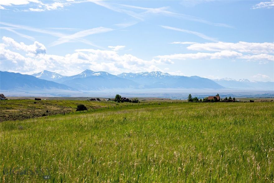 This 5.12-acre lot offers a level, grassy landscape with superb panoramic views, making it an excellent site for your dream home. The property is ideal for a variety of home designs, especially those that capture the amazing views of the Tobacco Root Mountains, the Madison Range, the Revenue Rocks and Ennis Lake.    Access is via a 30-foot easement, though the driveway has not yet been constructed. Fiber optics are available at the lot, and power is nearby.
Outdoor enthusiasts will appreciate the proximity to public lands, including the Deerlodge National Forest, which features mountain lakes and hundreds of miles of trails for motorized vehicles and horseback riding. The charming town of Ennis is just 20 minutes away, with Bozeman an easy hour’s drive. Covenants require earth-toned exteriors, ensuring a cohesive and natural aesthetic that highlights the spectacular views surrounding the property.  Adjoining Tract 4 (5.12A) is for sale too.