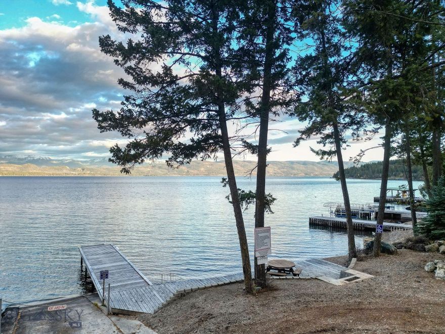 Rare Lakeside Opportunity – Two Bordering Lots with Flathead Lake Access & Panoramic Mountain Views. Discover a rare opportunity to own one—or both—of these beautiful bordering lots just moments from the shores of Flathead Lake in Lakeside, Montana. Each parcel offers access to the private homeowners’ lakefront area featuring a boat ramp, picnic area, and dock, allowing you to enjoy effortless days on the water. Set on a gentle slope with expansive views of Flathead Lake, the Swan Mountain Range and Glacier National Park, these lots capture the best of Northwest Montana’s natural beauty. The terrain provides excellent options for a daylight basement or multi-level design, making the most of the lake and mountain views. Just a short drive to Lakeside’s restaurants, shops, and marina. Community water is on the lot and covenants allow for short term rentals. Purchase individually or together to create your own slice of Montana paradise—where mountain views meet Flathead Lake living.
