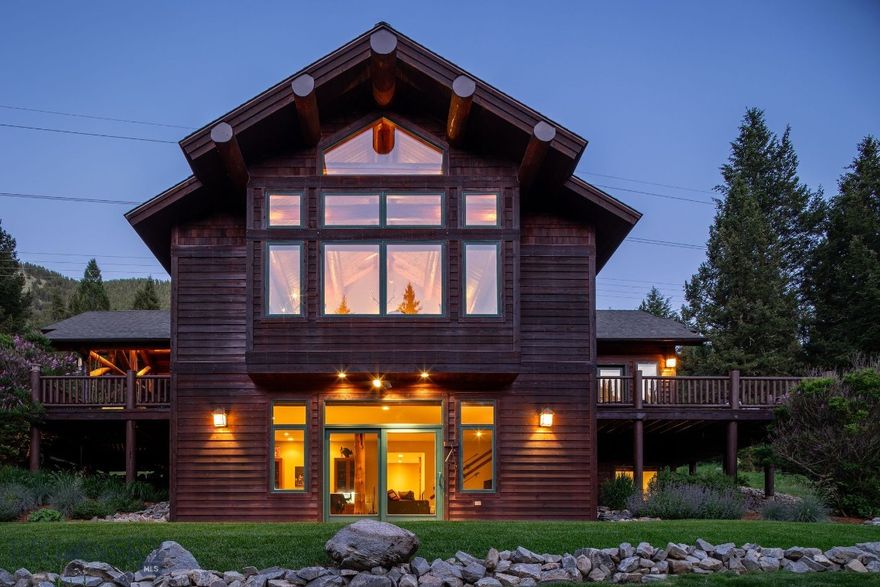 Experience the best of Montana living with this fully furnished mountain retreat located on 10 private acres in Gallatin Canyon. Just minutes from Big Sky and steps from the world-famous Gallatin River—a renowned blue ribbon trout fishery and world-class fly-fishing destination—this property offers unmatched access to outdoor recreation, fishing, hiking, and wildlife. It directly borders Gallatin National Forest, unlocking millions of acres of public land that stretch all the way to Yellowstone National Park.
The custom-built home blends rustic charm with modern comforts. The main level features an open-concept living area with vaulted ceilings, fireplace, custom metal artwork, and floor-to-ceiling windows that capture expansive mountain views. A spacious, covered outdoor patio extends the living space and includes a wood-burning fireplace—perfect for year-round gatherings and enjoying the fresh mountain air. The primary suite is also located on the main floor, offering convenience and privacy. The walk-out lower level includes two additional bedrooms, a large recreation room with wet bar, and access to a stone patio and flat lawn—ideal for outdoor entertaining.
Additional features include a heated detached garage with a workshop and an unfinished upper level offering potential for future expansion. The beautifully landscaped grounds include a horseshoe pit and a teepee, adding unique character to the outdoor space.
Whether you're seeking a full-time residence or vacation getaway, this rare offering combines privacy, scenery, and proximity to Big Sky’s amenities. Zoned for flexibility and potential additional structures, it’s a true legacy property.