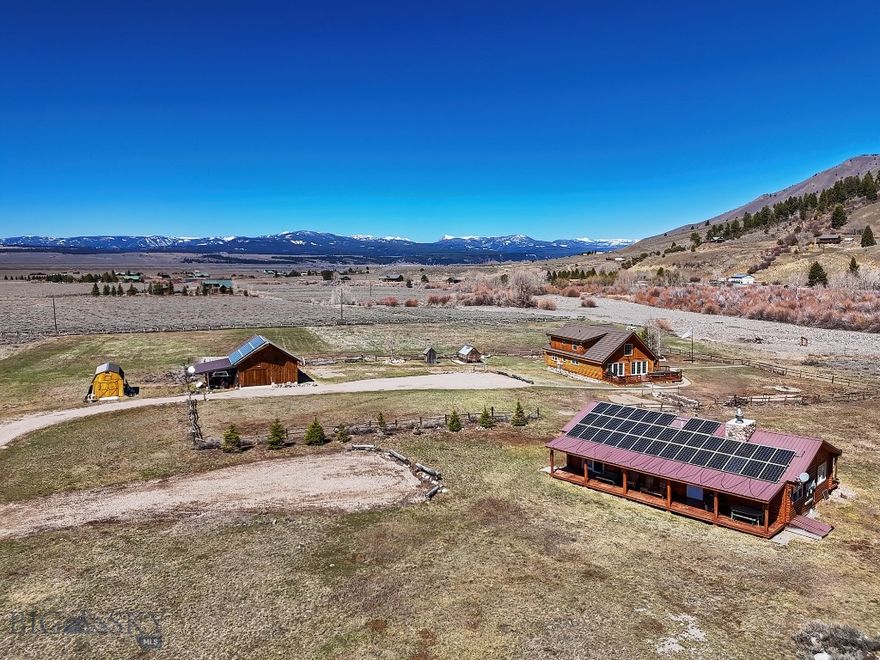Business Opportunity!! Live, Work & Play – Mountain Spirit Angler’s Turnkey Fishing Retreat – Charming 3-bedroom, 2-bath log home comes with a fully furnished 4-bedroom guest cabin and private walking access to the legendary Madison River—perfect for some of the best wade fishing you'll find on the upper Madison. The property also borders Sheep Creek and sits on over 20 acres of gorgeous Montana landscape, with stunning mountain views from the front and side decks.

The main house is warm and welcoming, featuring a spacious great room with vaulted ceilings, a beautiful rock fireplace, and an open kitchen and dining area that leads out to the deck—ideal for relaxing or entertaining. On the main level, you'll find two bedrooms and a full bath, while upstairs includes the primary suite, an additional loft bedroom, and a cozy loft area.

The 1,248 sq ft guest cabin is powered by a solar system and split into two fully furnished units, with a total of 7 beds and 2 kitchenettes—great for hosting family or renting out short- or long-term. 
There's also a large detached garage/shop with a utility room, plus two bonus rooms that can be used as offices, craft spaces, or extra guest rooms—each with their own bathroom. Outside, you'll find mature landscaping, a greenhouse, and fenced pastures with classic jack leg fencing.
This is a rare opportunity to enjoy space, views, and direct river access all in one spot!

Approximately 40 miles South of Ennis, located on the edge of the Lee Metcalf Wilderness area just down from Quake Lake and close to Cliff and Wade Lakes. Just miles from West Yellowstone, the western gate to Yellowstone National Park.  Henry's Lake is a few miles down the road and Henry's Fork is ten miles further.  
This is a great income property along with an amazing place to live!!