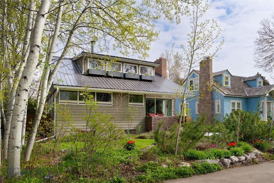 This property delivers a rare combination of walkability, income flexibility, and mountain lifestyle—just blocks from Montana State University and blocks to downtown Bozeman. The home has been thoughtfully updated by its owner. Integrate into Southside Bozeman living and enjoy all of the conveniences of everything being so close!

The main level offers an inviting living room with fireplace, an open kitchen and dining area, plus seamless access to a private backyard oasis with a deck that functions as an outdoor living room, a firepit for gatherings, a large garden area, a greenhouse with a sauna and 2 garages. A main-floor bedroom and full bath provide flexibility for guests or office space. Upstairs, the primary suite is a true retreat, featuring a woodstove and elevated windows that frame views of the Bridger Mountains—an anchor space that captures the essence of Bozeman living.

The lower level is where this property doubles as a guest retreat or a rental space. A fully equipped guest apartment includes a second kitchen, two bedrooms, full bath, a 2nd laundry, and a dedicated theater room. Whether utilized for long-term rental income, medium-term housing for traveling professionals, or multigenerational living for kids or parents that visit occasionally, this space creates a compelling opportunity to offset ownership costs while maintaining privacy and functionality.

Outdoor amenities elevate your downtown experience even further. A tiered deck flows to a firepit gathering area, complemented by the garden, greenhouse, and integrated sauna—features increasingly valued by buyers prioritizing wellness, sustainability, and self-sufficiency. Alley access enhances usability with additional parking and space for an RV or camper, while two additional structures—including a two-car garage with storage and a secondary garage with telescoping windows—offer versatility for gear, workshop use, or a mancave. If you have dreamed of a downtown home that is move in ready, this is it!