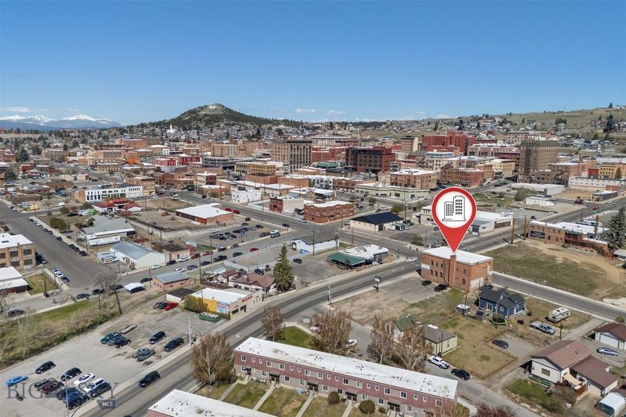 Historic building, reputable uptown business, and a large parking lot! At almost 9000 square feet with a 0.567 acre lot, this versatile property is waiting for a new purpose, or for a new owner to continue the existing pawn shop business that is already there. Built in 1899, Butte's Fire Station #2 housed the assistant fire chief and a 10-man crew from 1899 to 1931, serving Butte's warehouse district. From 1931 to 1987, the property was operated as a VFW Hall/Bar for the Auxiliary of the Veterans of Foreign Wars in Butte, holding many events for veterans as well as American Legion boxing events in the basement. In 1991, the former dance hall and bar was converted to a pawn shop, which the current owners have operated since 2000.
All pawn shop inventory is available. The business buys, pawns, and sells items of all kinds. Guns, gold, electronics, and items ranging from cheap to expensive & rare are sold at this local Uptown business.
Very close proximity to Butte High School, downtown Butte, and a large housing complex. Upstairs features a floating dance floor, an original bar from the VFW, and a kitchen/concessions room.
Additionally to the 1899 building and parking lot, this property is also being sold with 207 Curtis, a small home on the side of the parking lot. Built in 1920, 207 Curtis is one of the few surviving Cabbage Patch shacks from the notorious Cabbage Patch slums of Butte; which were mostly demolished in 1940.
This property has a long running history in Butte since 1899. It can be purchased along with the pawn shop business, or can be purchased to create in new business in a great location!