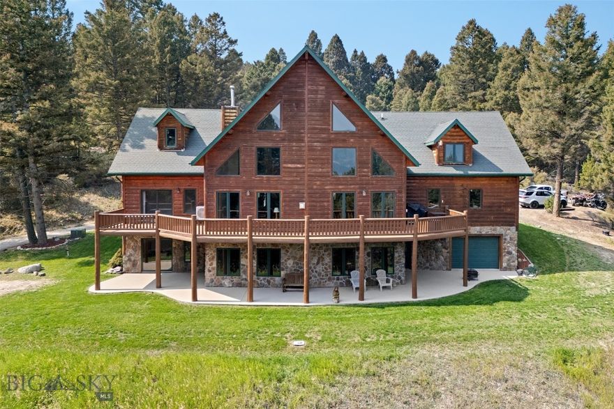 Just minutes from Butte, this stunning 5,916 sq. ft. custom-built home offers the perfect blend of Montana’s natural beauty and modern comfort. Set on 16.38 secluded acres, the property is surrounded by mature trees, dramatic rock outcroppings, and sweeping mountain views—creating a private sanctuary with a true sense of place.
Inside, the home features 5 spacious bedrooms, 3 bathrooms, a versatile office/den, and a bonus room that would make a perfect media room. The walk-out basement includes a full kitchen, ideal for hosting guests, extended family, or entertaining with ease.
The great room showcases soaring 28-foot ceilings with a striking rock fireplace as its centerpiece, complemented by finished log accents sourced from the property itself. Expansive windows and a wraparound deck invite you to take in the breathtaking views of the surrounding valley and peaks.
Additional highlights include:
Double-car attached 750 sq ft garage plus single door 750 sq ft garage for storage or workshop use
Landscaped yard with underground sprinklers
Seamless indoor-outdoor living with decks and gathering spaces
Large master bedroom with rock fireplace,  en-suite bathroom featuring a jetted tub and walk in shower and a spacious closet
From its thoughtful design to its pristine setting, 2171 Janney Rd embodies the Montana lifestyle—where comfort, craftsmanship, and nature come together.