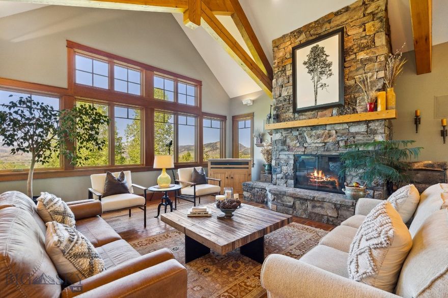 Discover refined Montana living in this beautifully updated custom home, ideally located in the prestigious Eagle Rock Reserve. Nestled at the end of a quiet private road, this exceptional property offers unparalleled privacy and direct access to thousands of acres of adjacent public land, creating a true outdoor paradise. Residents enjoy exclusive access to approximately 750 acres of private shared land, featuring scenic trails, a horse facility, private ponds and breathtaking panoramic views of surrounding mountains and forest. The area is teeming with wildlife year-round, offering an immersive Montana experience right outside your door.  Inside, you’ll find three spacious bedrooms and five updated bathrooms, each showcasing meticulous attention to detail. The heart of the home is an expansive great room anchored by a dramatic stone wood-burning fireplace. Soaring ceilings with handcrafted beams, circle-sawn wood flooring, and in-floor radiant heat add warmth and character to the main level.  The newly remodeled gourmet kitchen is a chef’s dream, featuring quartz countertops, Wolf range, a walk-in pantry, and refined touches such as toe-kick lighting. Just off the kitchen, a sun-drenched four-season room with a cozy gas fireplace provides the perfect retreat to enjoy Montana’s changing seasons and wildlife viewing. Also on the main level, you'll find a generous home office, a ¾ bath and a well-appointed laundry room designed for everyday convenience. The luxurious primary suite is a private sanctuary, offering walk-out deck access, a gas fireplace, and a spa-inspired bathroom complete with a soaking tub and modern finishes.  The walk-out lower level features a spacious family room, a dedicated theater/media room, and two additional bedrooms, including one with an en-suite bath. All three lower-level bathrooms have been tastefully renovated with custom cabinetry, designer tile, under-cabinet lighting, and heated floors for added comfort. A dedicated hobby shop and steam shower room are also located on this level.  Additional highlights include a heated three-car garage, new windows, new cedar siding, new roof shingles, and a long list of premium upgrades completed within the last four years. Every element of this home reflects exceptional craftsmanship and a deep appreciation for quality.  This is a rare opportunity to own a truly distinctive property in Eagle Rock Reserve.