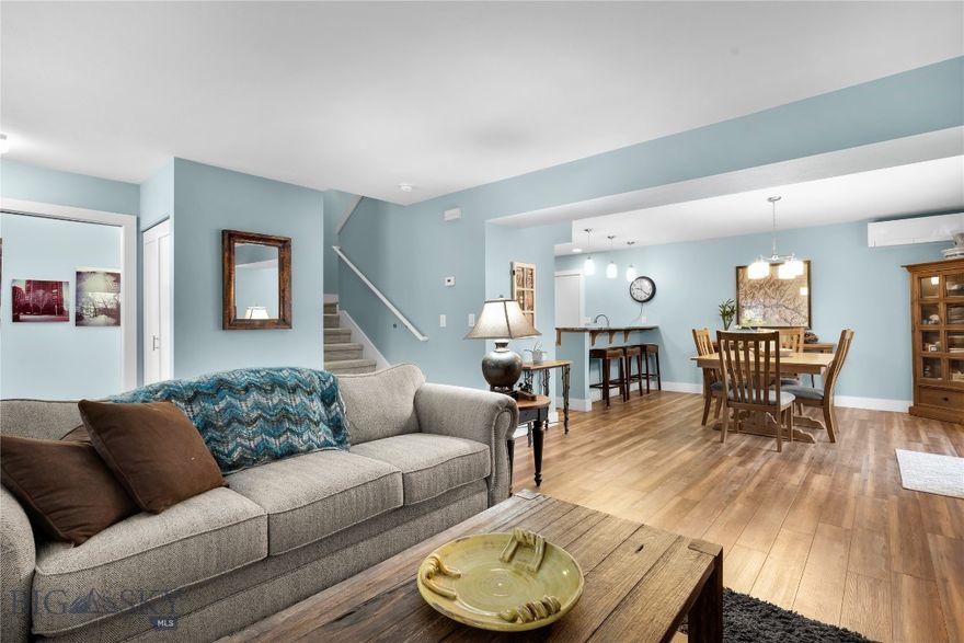 Nestled at the end of E College, this well-located condo is a rare opportunity in a highly sought-after pocket of town. This tucked-away setting is often favored by those familiar with the area, with the Gallagator Trail right out the front door—providing immediate access to Bozeman’s expansive and growing trail system. The condo has been thoughtfully maintained and updated over the years and features a main-floor powder room, LVP flooring, and refreshed interior paint. The updated kitchen, complete with a pantry, is positioned toward the interior of the unit.  The kitchen remains open to the dining area and sliding glass door that leads to the west facing deck.
Upstairs are two en-suite bedrooms, offering excellent privacy in this two-bedroom layout. The owner’s suite includes an updated bathroom with a tiled shower and dual vanity, along with a spacious walk-in closet featuring a window that truly elevates the space. Multiple windows bring in abundant natural light. The second bedroom also offers a generous closet, a full bathroom, and its own west facing balcony. A two-car garage, additional parking, and an unbeatable downtown location complete this truly distinctive condo.