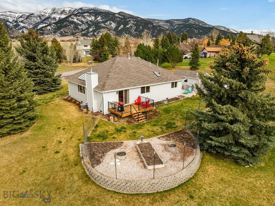 Tucked at the foot of the Bridger Mountains, this delightful property is located just outside Bozeman city limits, blending rural tranquility with easy accessibility to town. Featuring single-level living with a functional floor plan, amazing Bridger Mountain views, thoughtful updates and exceptional storage, this home sits on a lush one-acre parcel that feels like a private park. Located only minutes to popular trailheads and public land access, shopping, dining, medical and other area amenities. Just a few of this home’s numerous upgrades include a new roof in 2025 w/warranty, fresh exterior paint, new paver patio and deck, updated concrete, raised garden beds, fiber internet, updated furnace and central A/C. Interiors have been upgraded with 6” baseboards, new solid wood doors, engineered hardwood flooring, tile bathrooms and central vac. The living room features windows that capture the surrounding views. The spacious kitchen features stainless appliances, gas range, and granite counters. The dining room features a gas fireplace and offers great access to the new exterior deck and fenced garden, raised garden beds and patio areas. Primary suite features a walk-in closet and refreshed bath with a generously sized tile surround shower with glass enclosure, two sink quartz vanity and a heated towel bar. Two additional bedrooms share an updated hall full bath The bonus/recreation room allows for versatile use. The oversized 2-car insulated and heated attached garage features stair accessed loft storage. Enjoy the expansive 1,200 sq ft lower-level storage area - carefully excavated by the previous owner, every surface has been encased in concrete to create a clean, conditioned environment. This unique space serves as ideal pantry and secure storage area for everything from bulk provisions to outdoor equipment while also providing easy access to the home's utilities. Outside an additional separate insulated hobby shed features even more covered storage behind for lawn/snow equipment. The property features numerous hardscaped patios and outdoor areas – the perfect spots to enjoy watching the sun rise over the mountains with morning coffee or hosting parties and summer BBQs. Relaxed neighborhood CCRs allow for trailer storage. This home is conveniently located with easy access to Yellowstone Int'l Airport, 35-minute drive to Bridger Bowl. Minutes to blue ribbon fishing. 1 hour to Big Sky. Don’t miss the 360 VR Matterport Tour!
