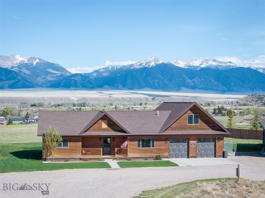 Set on an elevated 3.439-acre bench lot with panoramic views of the Madison River Valley and the Madison Mountain Range, this well-built property offers a hard-to-find combination of location, functionality, and flexibility. Those incredible views carry from inside the home all the way out to the redwood deck, yard, and firepit. A convenient walking path to downtown Ennis, local schools, and amenities is nearby.
This 2,913 SF home is well laid out for one-level living and entertaining. The primary suite on the main floor includes French doors to the deck, a walk-in closet, a clawfoot tub, and double sinks. The living room features solid walnut hardwood floors, vaulted wood ceilings, a gas fireplace, and mountain views. Two guest rooms share a ¾ bath, and a powder room is available for guests. The well-lit kitchen is equipped with alder cabinetry, a walk-in pantry, ample cabinet storage, bar seating, and a dedicated dining room.
A large bonus space above the garage includes a half bath and a small wet bar — well-suited for a home theater, craft room, or guest overflow.
The 900 SF guest apartment, added in 2023, is a standout addition. A fully self-contained one-bedroom unit with vaulted ceilings, a pellet stove, full kitchen, washer/dryer, and a ¾ bath — well-suited for guests, rental income, or multi-generational living.
The shop and both garages have epoxied floors. Properties with this much workspace and storage don't come up often. An oversized attached 2-car garage connects to the main home, a 900+ sq. ft. heated shop connects to the guest apartment, and a separate 30x48 mechanic's shop includes a 12-ft Atlas lift and a 30x12 side bay with three garage doors total.
Outside, a redwood deck and firepit are perfectly positioned to take in the mountain views. A circular driveway, sprinkler system, and well-maintained grounds keep things tidy and functional. A dry cabin with French doors adds useful extra space.
Additional details: offered fully furnished, fiber optic service, LED lighting throughout, Andersen windows, owned propane tank, well and septic. HOA fee is $200/year.