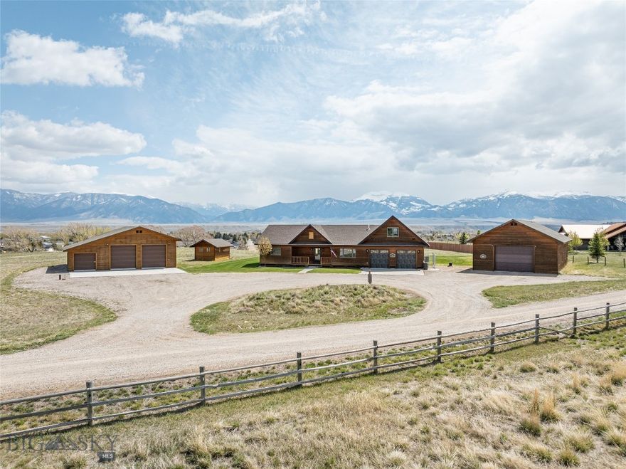 Set on an elevated 3.439-acre bench lot with panoramic views of the Madison River Valley and the Madison Mountain Range, this well-built property offers a hard-to-find combination of location, functionality, and flexibility. Those incredible views carry from inside the home all the way out to the redwood deck, yard, and firepit. A convenient walking path to downtown Ennis, local schools, and amenities is nearby.
This 2,913 SF home is well laid out for one-level living and entertaining. The primary suite on the main floor includes French doors to the deck, a walk-in closet, a clawfoot tub, and double sinks. The living room features solid walnut hardwood floors, vaulted wood ceilings, a gas fireplace, and mountain views. Two guest rooms share a ¾ bath, and a powder room is available for guests. The well-lit kitchen is equipped with alder cabinetry, a walk-in pantry, ample cabinet storage, bar seating, and a dedicated dining room.
A large bonus space above the garage includes a half bath and a small wet bar — well-suited for a home theater, craft room, or guest overflow.
The 900 SF guest apartment, added in 2023, is a standout addition. A fully self-contained one-bedroom unit with vaulted ceilings, a pellet stove, full kitchen, washer/dryer, and a ¾ bath — well-suited for guests, rental income, or multi-generational living.
The shop and both garages have epoxied floors. Properties with this much workspace and storage don't come up often. An oversized attached 2-car garage connects to the main home, a 900+ sq. ft. heated shop connects to the guest apartment, and a separate 30x48 mechanic's shop includes a 12-ft Atlas lift and a 30x12 side bay with three garage doors total.
Outside, a redwood deck and firepit are perfectly positioned to take in the mountain views. A circular driveway, sprinkler system, and well-maintained grounds keep things tidy and functional. A dry cabin with French doors adds useful extra space.
Additional details: offered fully furnished, fiber optic service, LED lighting throughout, Andersen windows, owned propane tank, well and septic. HOA fee is $200/year.