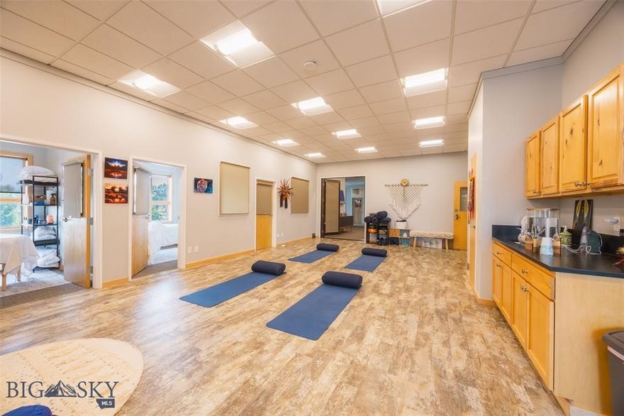 Unit G, (1678 sq ft) which contains a large studio utilized for formal and informational educational classes, wellness practices, and classes hosted by practitioners. This unit also comprises five treatment rooms. While there is potential to maintain the current vision, there are also opportunities for the new owner to implement their own ideas for growth. Most leases are not long-term, allowing for flexibility in providing notice when necessary; however, existing tenants are valued and many would prefer to continue their leases.   The homeowners’ association (HOA) is in good standing and has successfully completed significant exterior upgrades. Additional amenities of the property include an elevator providing access to the second floor, shared bathrooms in common areas, and individual air conditioning units for each unit. Furthermore, the property boasts extensive common area parking with over 20 on-site spaces along with ample off-street parking.   There is an option to purchase separate spaces, Units E (1421 sq ft), and F (1633 sq ft). All three units are legally distinct units. While maintaining a cohesive flow is recommended, splitting these units is also feasible.  Seller is a Licensed Broker in the State of Montana.