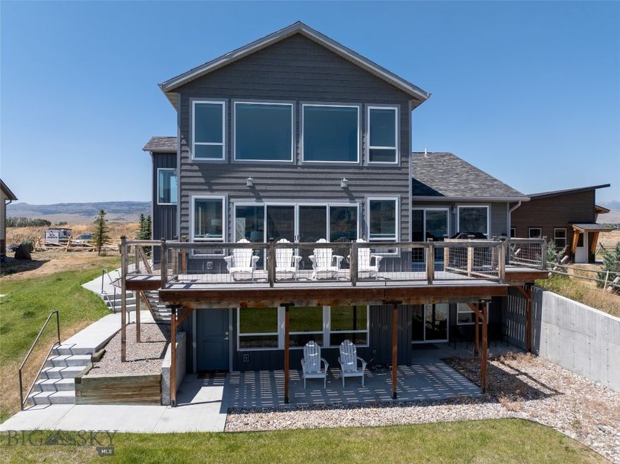 Located on the peaceful side of Ennis Lake, 22 Jordan Lane N offers 92.42+/- feet of prime lakefront location with stunning views of the Madison Range, Lone Peak, and the Jack Creek Canyon.  This custom-built home features 4 bedrooms, 3.5 bathrooms, and a total of 4,508 square feet of living space, including a 1,700 square foot apartment with 2 bedroom, 1 bathroom, and a full kitchen on the lower level.
The spacious open floor plan includes a chef’s kitchen with upgraded stainless steel appliances, an impressive island with seating, a large hidden pantry, radiant in-floor heat, unique light fixtures and many custom upgrades.  The living and dining areas are perfect for entertaining, with a cozy modern propane fireplace as a focal point when you are not looking out the floor-to-ceiling windows to the immense view of the lake and mountains. Connect with the views even better from the wide deck that runs the width of the home. The large master suite is located on the main floor and features a soaker tub and walk-in closet and opens to the deck overlooking the lake. A second bedroom with a private bath is located on the upper level.
The lower level is ideal for guests or family members and  has two additional bedrooms, a full bath, and a second full kitchen, all with direct access to the outdoors and a private entrance. A spacious patio and sidewalk area provide ample space for outdoor living and recreation at this level.
The property offers private lake access on a path from the house, and the potential for a dock to be added for water access. There is extra gravel parking for guests.  Enjoy a peaceful lakeside retreat with fishing, boating, and breathtaking mountain views. Additionally, the property allows for short-term rentals, making it a versatile investment or recreational property. This home lives well as a primary residence or as an investment property with income potential and is being offered furnished.