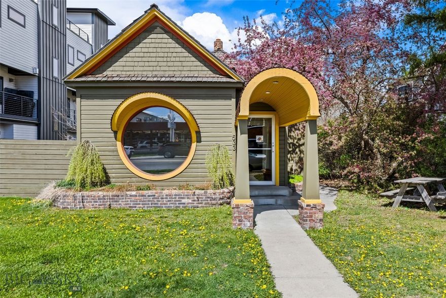 533 E Mendenhall presents a rare commercial opportunity just one block north of Main Street in downtown Bozeman. This distinctive historic building features eye-catching curb appeal with its iconic round window and arched entry, paired with a thoughtfully updated interior showcasing modern design, warm wood finishes, and flexible workspace. Ideal for office, retail, or studio use, the property offers excellent visibility, alley access with rear parking, additional street parking, and potential for future development or expansion.