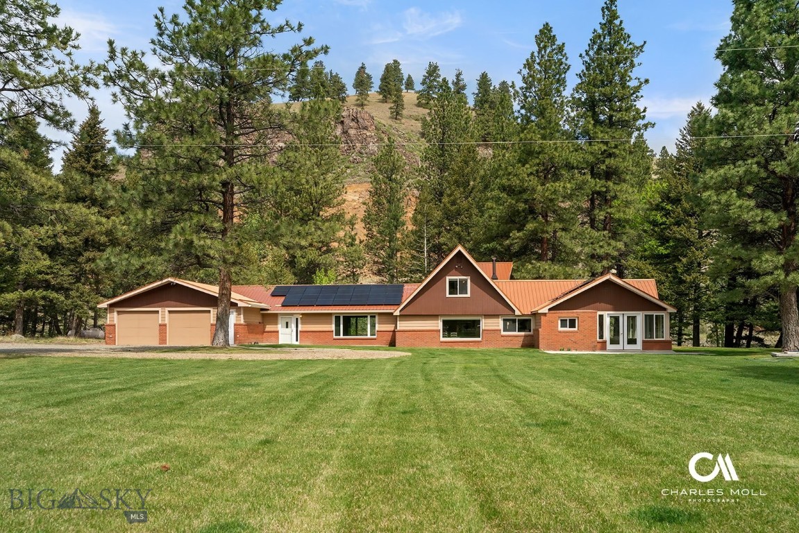 Tucked away along a quiet stretch of Ten Mile Creek, this one-of-a-kind property offers the best of Montana living—peace, privacy, and private creek frontage, all just 15 minutes from downtown Helena. Imagine fishing off your own deck! It is a dream!! The home features 3 bedrooms + office/bonus room, 2 bathrooms, and offers main level living with 2 options for a primary bedroom. This one of a kind home radiates mid-century vibes while providing comfortable modern living spaces, all in a stunning creekside location.
Outdoors, the property shines! A generous multi-level deck is secluded by the trees and overlooks the creek, perfect for summer evenings, entertaining, or fishing. You can also fish from the private footbridge or shared driveway access bridge. The manicured lawn and mature trees create a park-like setting, inviting you to enjoy fresh mountain air year-round. Whether it’s gardening, relaxing by the water, or entertaining on the expansive deck, this property is a nature lover’s retreat.
Step inside to find a light-filled open layout highlighted by a spacious all-season sunroom where you can sip your morning coffee while listening to the creek just beyond the windows and watch wildlife in your yard. The spacious living and dining areas flow seamlessly for gathering and entertaining. The wood burning fireplace and gas stove are perfect for warming up in cooler weather.
The property has ample storage for all you gear, with 2 storage sheds and a separate shop/storage area in the attached 2 stall garage.
All of this serenity is paired with unbeatable convenience—just a short drive brings you to Helena’s vibrant downtown with its restaurants, shops, and cultural attractions. Whether you’re seeking a primary residence, a weekend escape, or a summer home, this home captures Montana’s timeless appeal, this is truly a rare find.