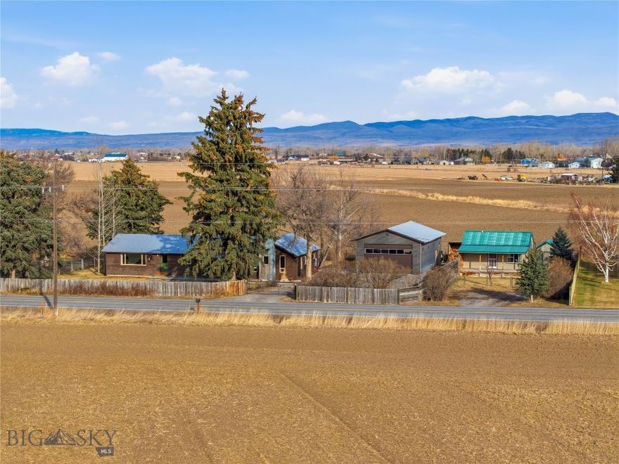 What more can you ask for?  No covenants, updated home, shop space, and a guest home -- all on an acre that is located close to the Gallatin River, and with easy access to Belgrade, Bozeman, and Big Sky!  This home was fully updated in 2020-2021, with new wood floors, a full new kitchen with soapstone countertops, and new bathrooms.  It has a smart layout, with 3 bedrooms on one end (or 2 bedrooms plus a sunny office or family room!), with a shared bathroom.  The kitchen is centrally located, along with a butler's pantry and laundry room, and is open to the large living area, featuring concrete floors and a woodburning stove to keep things cozy!  The master suite boasts a large walk-in closet and a full bathroom, and the large mud room is a dream!  Outside, you'll find both front and back decks to take in the mountain views, a fully fenced yard, space for your chickens, goats or horses (complete with a 2-stall loafing shed), and a large, 24x42 garage/shop -- giving you room for your cars, toys, and work space!  To top it all off, there's a cute tiny home (about 16'x24'), featuring a full kitchen, living area with a murphy bed, and a bathroom with a stacked washer and dryer!  Rent it out, or keep it open for your guests!  Properties like this don't come on the market very often!