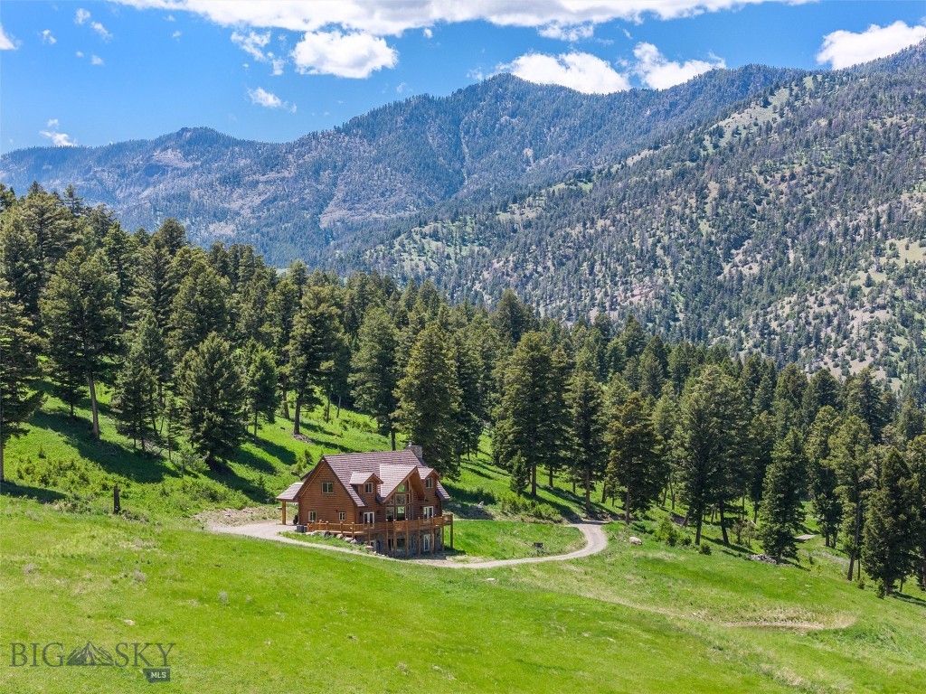 Escape to the untamed beauty of this freshly finished, custom log home resting upon 135 pristine acres in the foothills of Electric Peak, the highest point in Northern Yellowstone National Park. This gorgeous home offers inexhaustible views of Montana's stunning landscapes, and the land includes multiple build sites plus a small cabin, adding to the property's appeal.
The 3,542 sq ft main residence features 3 bedrooms, 4-3/4 baths, and an office that can serve as a fourth bedroom. Soaring ceilings, wood floors, and granite throughout the kitchen and bathrooms will leave you feeling as though you are living in a high-end mountain lodge. With its generous living areas, you will have ample space to entertain guests or simply retreat in tranquil solitude. Floor-to-ceiling windows frame a grass-swept field leading to stunning, unobstructed, panoramic views of the Absaroka Mountains. Here, you can experience the enchantment of witnessing moose, elk, bear, deer, and almost all of Yellowstone's wildlife from your backyard.
Close by, yet out of view of the primary home, lays a rustic dry cabin with one bedroom, a kitchen and living area, and an entryway. This cabin is a relic of this property's rich history, as the land was previously owned by one of the first ranching families who settled Gardiner in the 1800s.
Enjoy nearby public access to the Yellowstone River and Forest Service land, which offer endless recreational opportunities including floating, hunting, fishing, and hiking. For amenities and exploration, the quaint town of Gardiner and the historic Roosevelt Arch, the ceremonial entrance to Yellowstone National Park, is just 25 minutes away. Livingston is an hour's drive, with Bozeman 35 minutes beyond. Paradise Valley is also nearby, offering live music and dining at venues such as the Old Saloon, Sage Lodge, Music Ranch Montana, and Chico Hot Springs.
No commercial activity is allowed on this property, which is comprised of two deeded lots. Some of the water footage in the media is on the access easement, not the subject property. The Buyer is to verify all information.
Property in this area is extremely rare. Do not miss your chance to become a neighbor to Yellowstone National Park, one of America's most treasured natural wonders! Call now to schedule a private showing and make this extraordinary property your own.