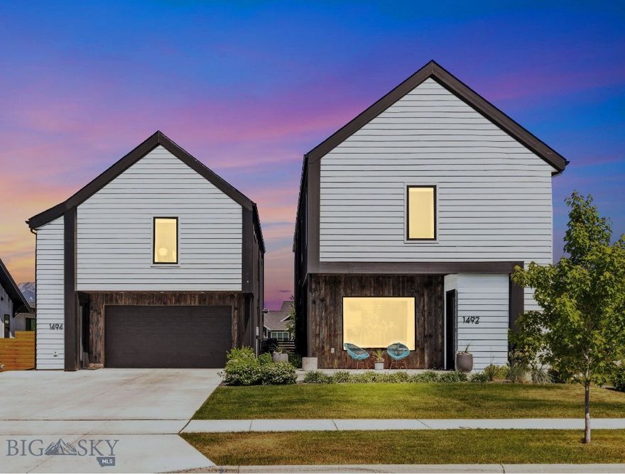 Your next chapter begins in this Architecturally Designed Custom Home + Detached Apartment (ADU) in Flanders Mill subdivision. Experience elevated Montana living in this impeccably crafted residence with a perfectly matched detached ADU, located in the heart of Bozeman’s desirable Flanders Mill. Just steps from parks and backing to HOA open space with year-round live water and uninterrupted Bridger Mountain views, this home offers a rare blend of nature, thoughtful design, and exceptional setting. The main home spans approximately 2,842 square feet and features four bedrooms and three and a half baths. A striking two-story foyer and soaring 10-foot ceilings on the main level set the tone for the architectural detailing throughout. The L-shaped galley kitchen combines form and function with quartz countertops, custom maple shelving, modern glass backsplash, stainless steel appliances, and a sleek counter window. The formal dining room and expansive living area with gas fireplace and 8ft tall sliding patio door, are perfect for entertaining or cozy nights in. The primary suite captures stunning Bridger views and offers a spa-like bath complete with floating vanities, a soaking tub, separate shower, and a spacious walk-in closet. A private guest suite includes a full ensuite bath, while all bedrooms feature elegant trayed 9-foot ceilings, adding dimension and airiness. Two more bedrooms and one full bath are also located upstairs. The detached ADU offers 702 square feet of stylish and flexible space above the detached garage. With a private bedroom, full bath with in-unit laundry, and a complete galley kitchen with stainless appliances, it’s ideal for guests, extended family, or rental income. Vaulted 9-foot ceilings in the living area open to a covered rooftop deck a tranquil setting with panoramic views of the Bridger Range, creating the perfect retreat. An extra-deep two-car garage adds versatility with its pull-through layout and overhead door to the backyard, making it well-suited for a gym, workshop, artist studio, or extra storage. Interior access to the kitchen ensures daily convenience, and the peaceful fenced backyard near HOA creek is complete with a relaxing outdoor sauna. This custom home with apartment has 2842 + 702 = 3544 sq ft is more than a place to live, it's a testament to intentional design and quality craftsmanship, nestled in one of Bozeman’s most desirable neighborhoods near schools.