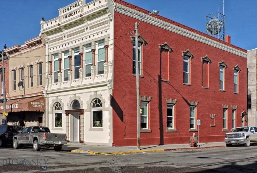 Discover a fully renovated historic brick building in the heart of downtown Dillon—perfect for a live/work setup. Offering 4,500 sq. ft. of finished space on two levels plus 2,500 sq. ft. of dry basement storage, this 1888 property blends timeless character with modern updates. Originally built for the Dillon National Bank in 1886, it was later home to the State Bank and Odd Fellows Lodge, the building now features restored original elements including maple floors, crown molding, and tile with a copper border. Recent upgrades include new electrical and plumbing, custom double-pane windows with Hunter Douglas shades, all new interior doors, updated lighting and fans, and fresh paint inside and out. The main level is ideal for retail or commercial use, featuring a porcelain-tile entry, solid walnut front door with Rocky Mountain hardware, and convenient bathroom with storage cabinetry. The upper level has been converted into a spacious 1-bedroom, 1-bath apartment with a loft, showcasing a new kitchen with appliances, a large island, a 4×6 walk-in tiled shower. An impressive 16' fir-plank ceiling includes upgraded insulation. The clean, dry basement includes abundant storage space and the original safe room with an iron staircase. A rare opportunity to live upstairs and operate your business below—all in a thoughtfully restored historic building. Schedule your showing today!