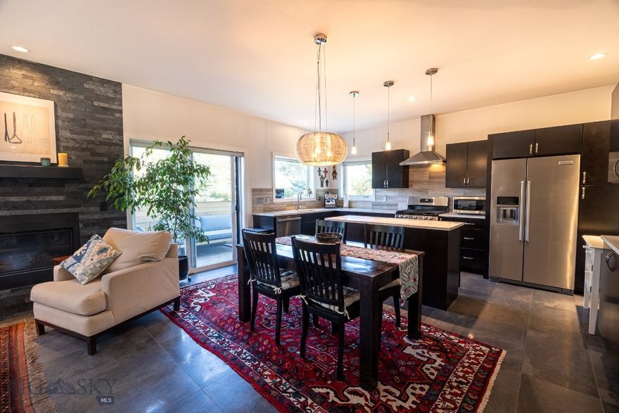 A rare blend of privacy, style, and convenience awaits in this beautifully designed detached condo—lives like a single-family home with none of the shared walls and all of the comfort.

Step inside to discover a sun-filled open layout anchored by a cozy gas fireplace and a sleek, modern kitchen featuring quartz countertops and recently upgraded appliances (range, dishwasher, washer & dryer). Italian porcelain tile adds a touch of elegance.

The spacious primary suite offers a walk-in closet and dual vanity en suite bath. A second bedroom enjoys generous natural light, and the upstairs den—with its own balcony and panoramic views—makes a perfect office, creative space, or optional third bedroom.

Outside, enjoy summer evenings on the private back deck or in the fenced yard. Central AC and a whole-house fan ensure year-round comfort. The single-car garage adds convenience, and the location puts you just minutes from parks, schools, shopping, and Bozeman’s vibrant N. 19th corridor.

End unit. No shared walls. Mountain views. Pride of ownership throughout. This one’s ready to welcome you home.