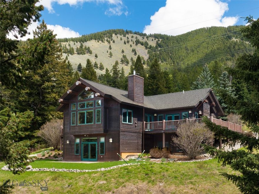 Experience the best of Montana living with this fully furnished mountain retreat located on 10 private acres in Gallatin Canyon. Just minutes from Big Sky and steps from the world-famous Gallatin River—a renowned blue ribbon trout fishery and world-class fly-fishing destination—this property offers unmatched access to outdoor recreation, fishing, hiking, and wildlife. It directly borders Gallatin National Forest, unlocking millions of acres of public land that stretch all the way to Yellowstone National Park. The custom-built home blends rustic charm with modern comforts. The main level features an open-concept living area with vaulted ceilings, fireplace, custom metal artwork, and floor-to-ceiling windows that capture expansive mountain views. A spacious, covered outdoor patio extends the living space and includes a wood-burning fireplace—perfect for year-round gatherings and enjoying the fresh mountain air. The primary suite is also located on the main floor, offering convenience and privacy. The walk-out lower level includes two additional bedrooms, a large recreation room with wet bar, and access to a stone patio and flat lawn—ideal for outdoor entertaining. Additional features include a heated detached garage with a workshop and an unfinished upper level offering potential for future expansion. The beautifully landscaped grounds include a horseshoe pit and a teepee, adding unique character to the outdoor space. Whether you're seeking a full-time residence or vacation getaway, this rare offering combines privacy, scenery, and proximity to Big Sky’s amenities. Zoned for flexibility and potential additional structures, it’s a true legacy property.