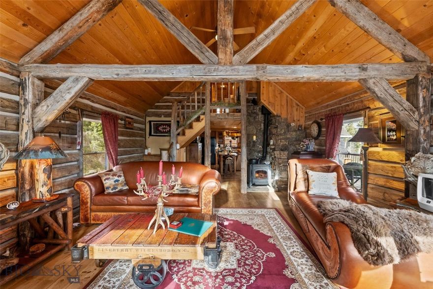 This beautiful, custom, hand hewn dovetail log home sourced from a homestead in the Snow Crest Moutains near Alder, MT, sits on 22.201 acres surrounded by woods, wildlife and mountains. The main home offers 2,376 sq. ft. of living space, encompassing 3 bedrooms, 3 bathrooms, and a 2-car garage. A cozy cottage feel is created throughout the home in the many details including the two gas fireplaces surrounded by moss rock hearths, a combination of slate and hardwood flooring, custom pine cabinetry, hammered copper sink, and exposed beams. The large master bedroom includes an en suite bathroom, walk-in closet, and opens to a patio which is perfect for enjoying your morning coffee or unwinding by the fire pit. Completing this property is a 700 sq. ft. detached 1-bedroom/1 bathroom ADU apartment with a proven track record as a successful vacation rental. Located just a short drive from both Bozeman and Livingston (about 15 minutes in either direction), the property is abundant in wildlife including moose, elk, deer and bear, and is bordered by two seasonal springs. The beautiful yard is set up with an underground sprinkler system and is filled with thoughtfully placed perennials. This property has housed horses in the past, complete with a loafing shed, water, and a fenced-in corral could easily be reinstalled. Enjoy the mountain views that complete this gorgeous and secluded setting. Schedule your showing today! By appointment only, please no drive-bys.