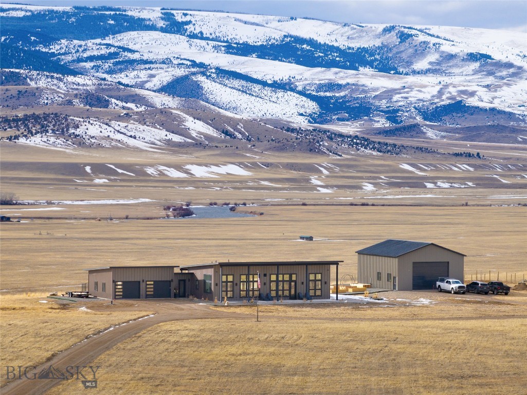 Discover the beauty of Montana at the Circle O Ranch. This 2,000 SF, 2 bedroom, 2 bath, custom-built, contemporary mountain home is set on over 40 acres. Enjoy 360-degree unobstructed views of the Madison, Gravelly, and Tobacco Root Mountains. The large, open-concept floor plan features a gourmet kitchen with Wolf Range and commercial Blue Star refrigerator, dining room and custom wet bar with wine fridge & icemaker, and a living room with a three-sided designer gas fireplace and floor-to-ceiling windows showcasing breathtaking views of Sphinx Mountain and the Madison River. Many trees have been planted along the driveway and around the property. There is a fenced orchard with numerous trees and a new lawn will be installed in June! Enjoy the courtyard overlooking the Madison River, with a beautiful wood-burning fire pit and extensive raised beds for gardening, or relax by the custom built-in gas firepit on the back deck. The subdivision offers private access, through BLM land, to the world-renowned blue-ribbon waters of the Madison River, perfect for epic fly fishing. For those needing extra space, there is a newly-constructed, 36’ x 48’ metal barn, fully-insulated, with a finished interior and plumbed for a future guest Casita or Mother-In-law apartment. The main driveway is directly off of US Highway 287 N, as well as an entrance off Bowman Lane S, within the subdivision. Two horses, mules, llamas or burros may be kept on the property. Circle O Ranch provides a quiet and peaceful lifestyle, just 15 minutes from the iconic fishing town of Ennis, and just an hour away from both Bozeman and Yellowstone National Park. Plus, the Madison Valley offers amazing recreational opportunities for hiking, trail riding, hunting, fishing (lakes, rivers and streams); snowmobiling, sightseeing, camping, golfing or just getting away from people! There is also access available on the private road to Big Sky for skiing, if you join the Madison Valley Ski club and have a season ski pass at Big Sky.